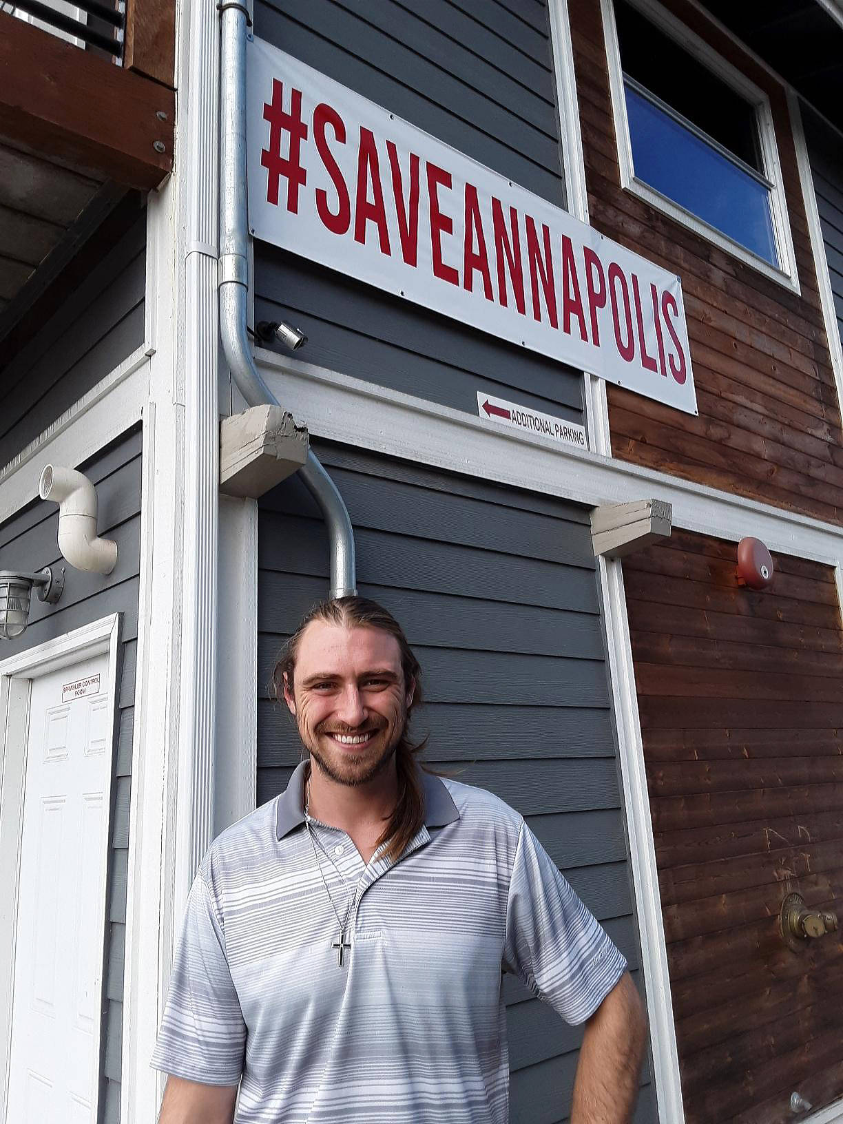 Photo by Jana Mackin                                Shawn Danubio, general manager of Whiskey Gulch, stands under a banner that calls social media attention to their movement to stop the city’s possible eminent domain action against the business.                                Shawn Danubio, general manager of Whiskey Gulch, stands under a banner that calls social media attention to their movement to stop the city’s possible eminent domain action against the business. (Photo by Jana Mackin)