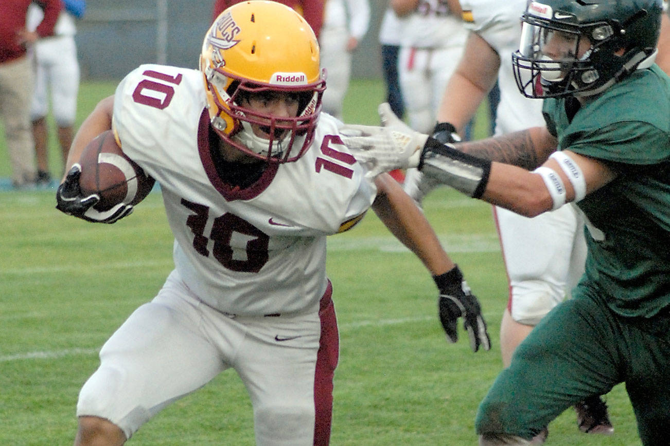 Kingston’s Kyler Coe-Yarr, left, fends off the defense of Port Angeles’ Tyler Bowen on Friday night at Port Angeles Civic Field. (Keith Thorpe/Peninsula Daily News)