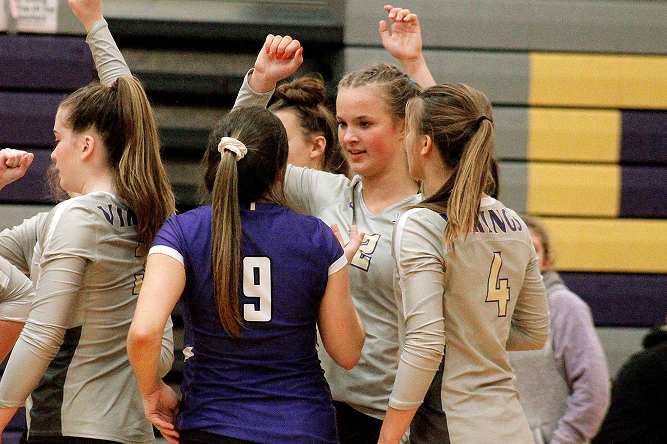 Maddie Pryde (12) celebrates a victory over Bremerton with Autumn Carver (9) and Emma Orness (4). (Mark Krulish/Kitsap News Group)
