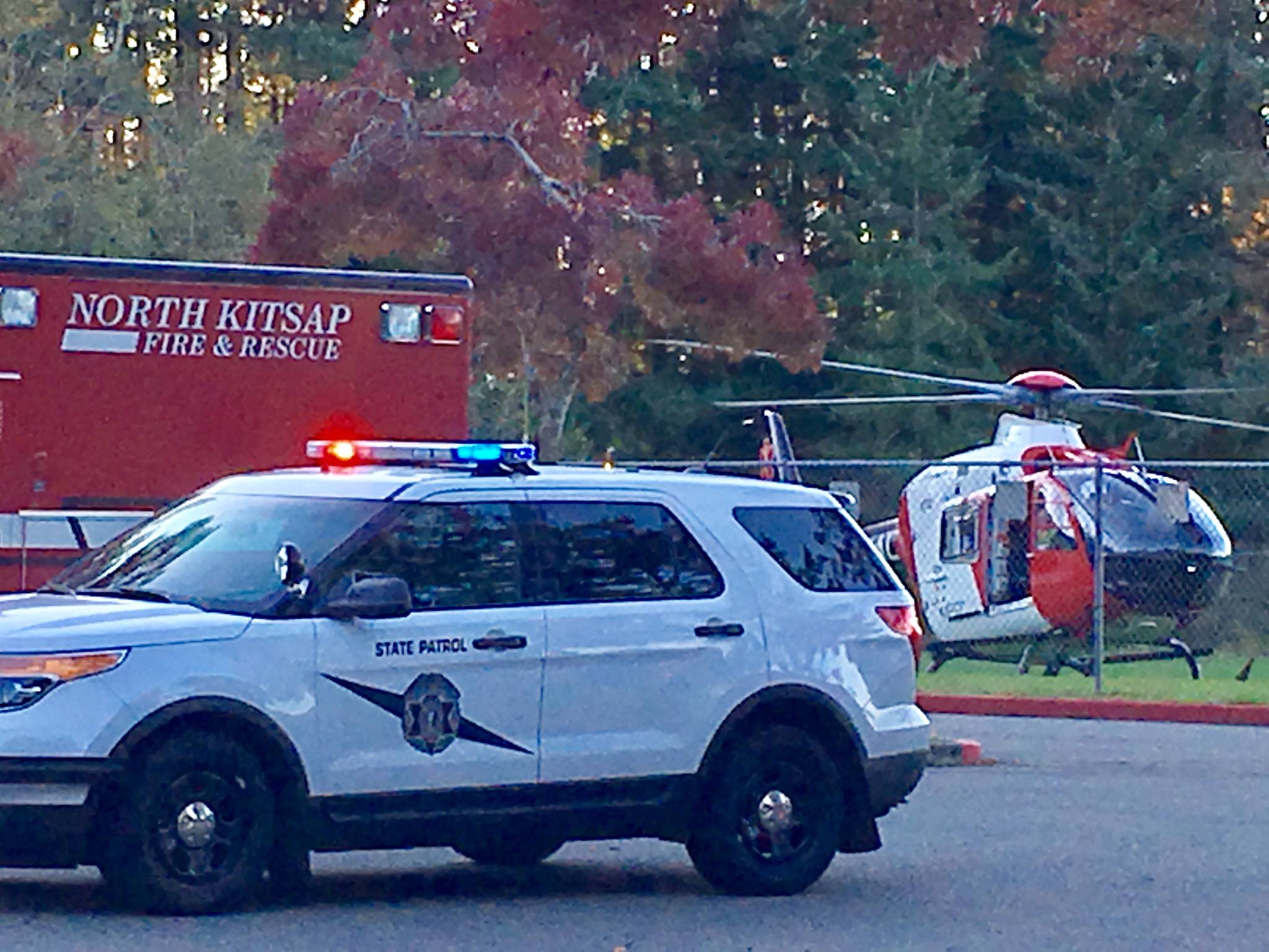 Responders from the Washington State Patrol, North Kitsap Fire & Rescue and Airlift Northwest at David Wolfle Elementary work to transport a motorcyclist to Harborview Medical Center. Photo Courtesy Holly Lawrence.
