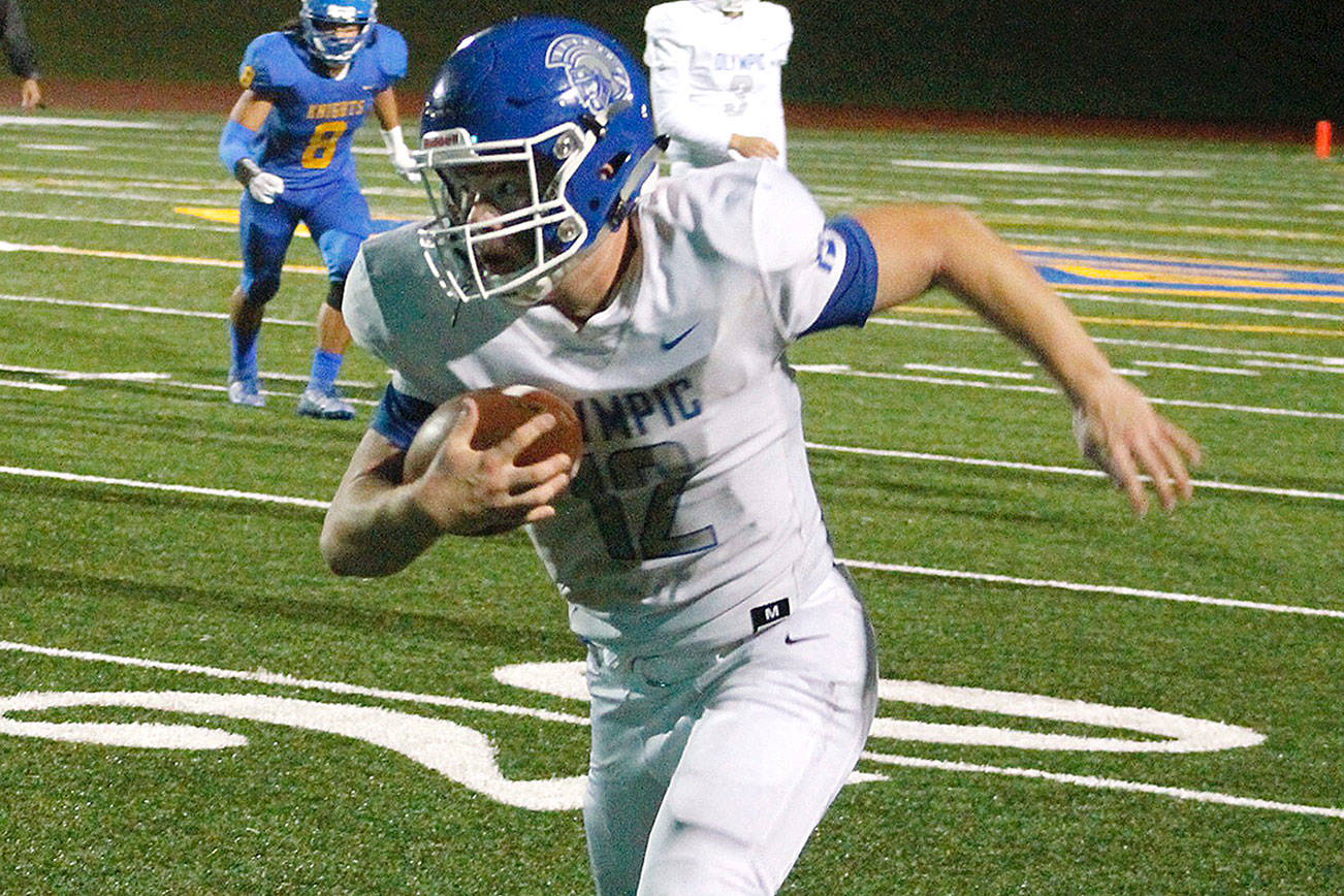 Olympic’s Anthony Turso takes a pass and looks upfield toward the end zone against Bremerton. The Trojans defeated the Knights 49-14. (Mark Krulish/Kitsap News Group)