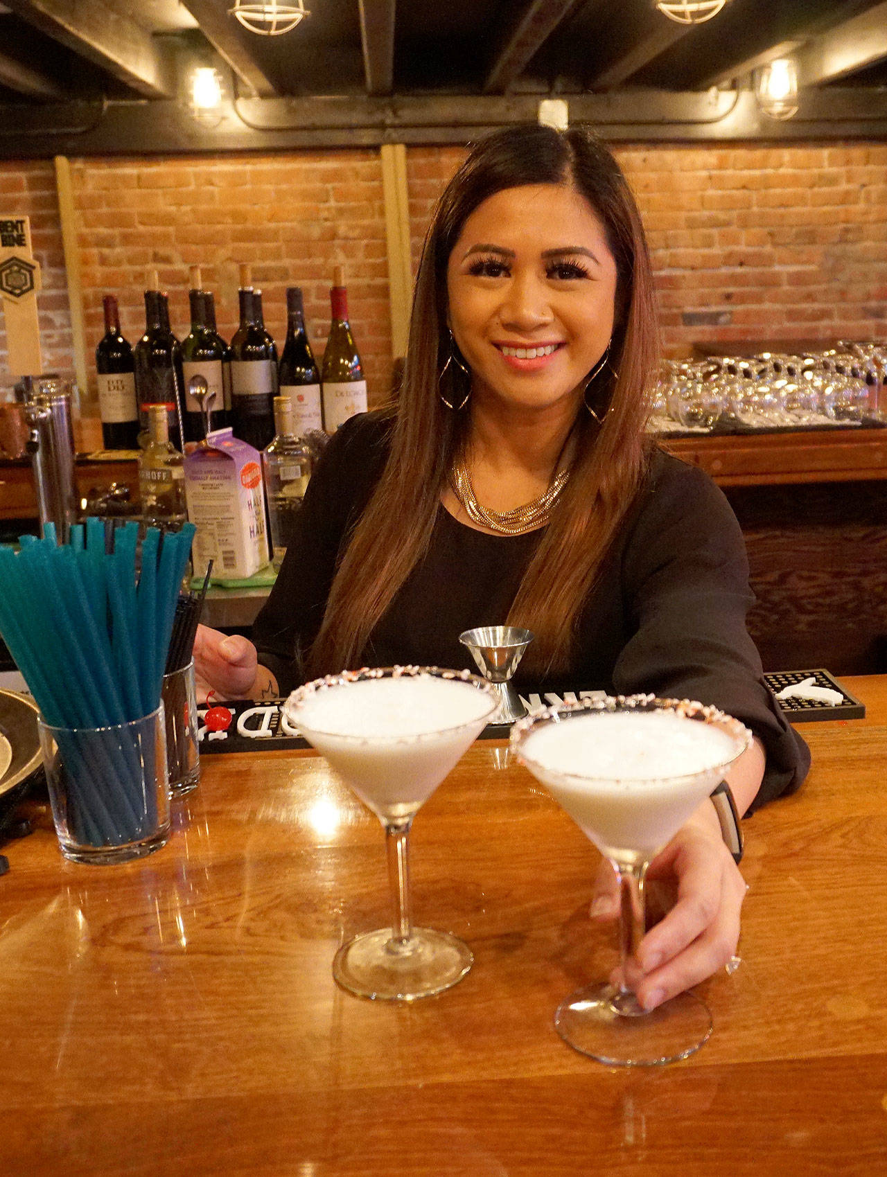 Carla Toizumi, head bartender at Bay Street Bistro, prepares drinks at the restaurant’s new bar. (Bob Smith | Kitsap Daily News)