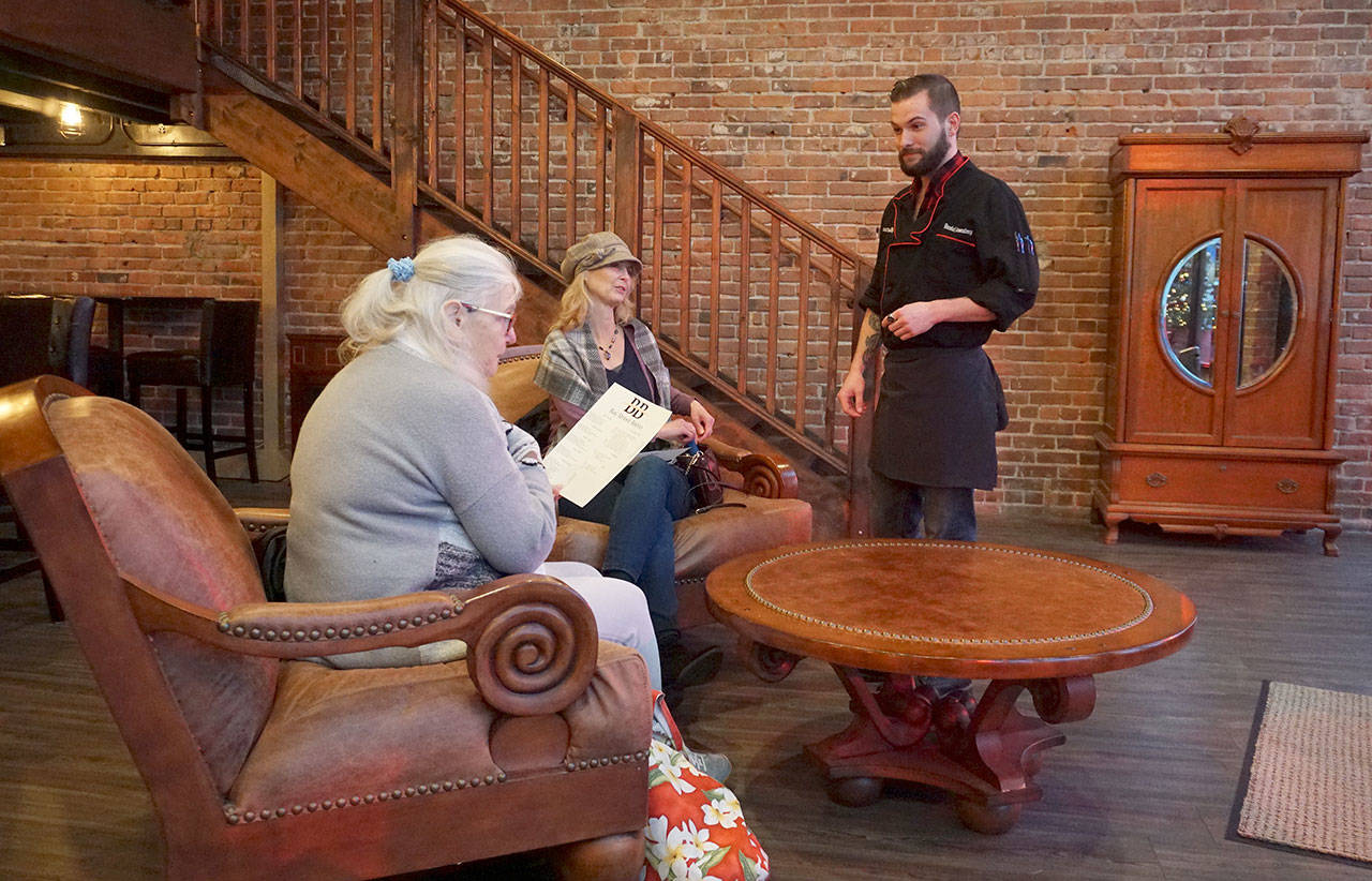 Executive chef Danny Rosenberg shares the restaurant’s daily specials with a pair of customers. (Bob Smith | Kitsap Daily News)