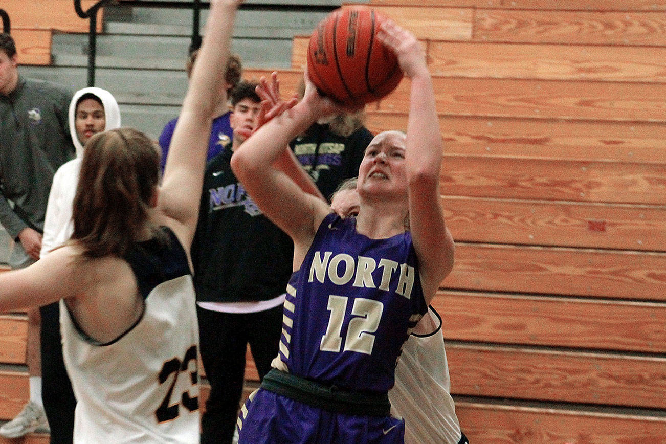 North Kitsap’s Grace Johnson takes a shot over Ellie Woolever of Bainbridge (23) in her team’s 53-45 victory on Dec. 9. (Mark Krulish/Kitsap News Group)