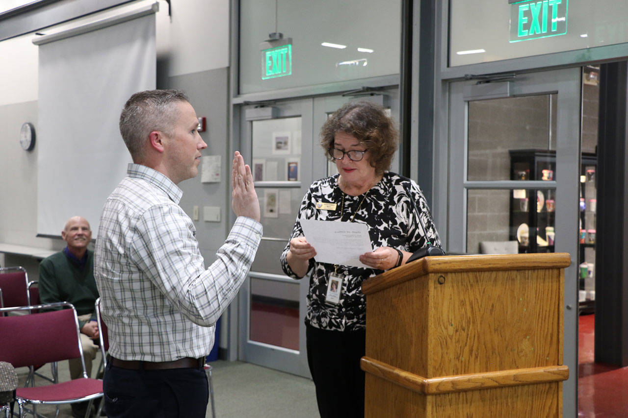 Mike Desmond was sworn in as a member of the North Kitsap School District by Poulsbo Mayor Becky Erickson on Dec. 12, 2019.