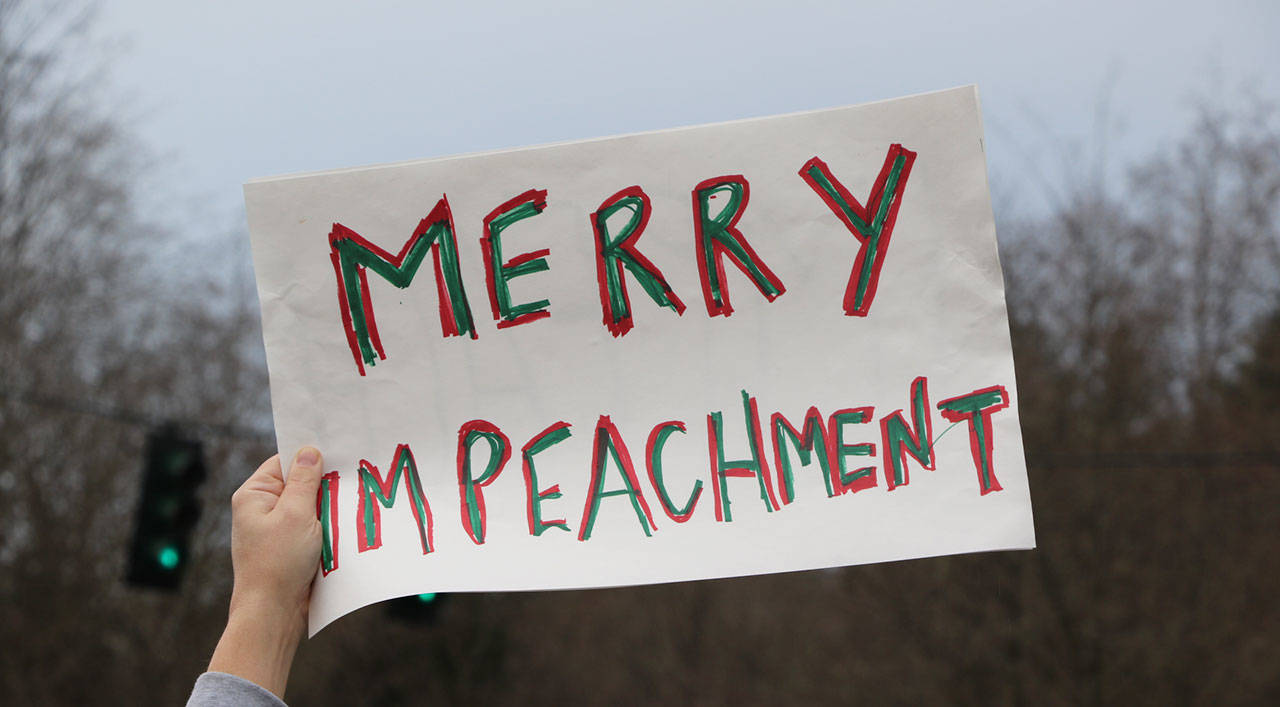 A cheeky sign marking the joy of the season and that of those who support impeachment.