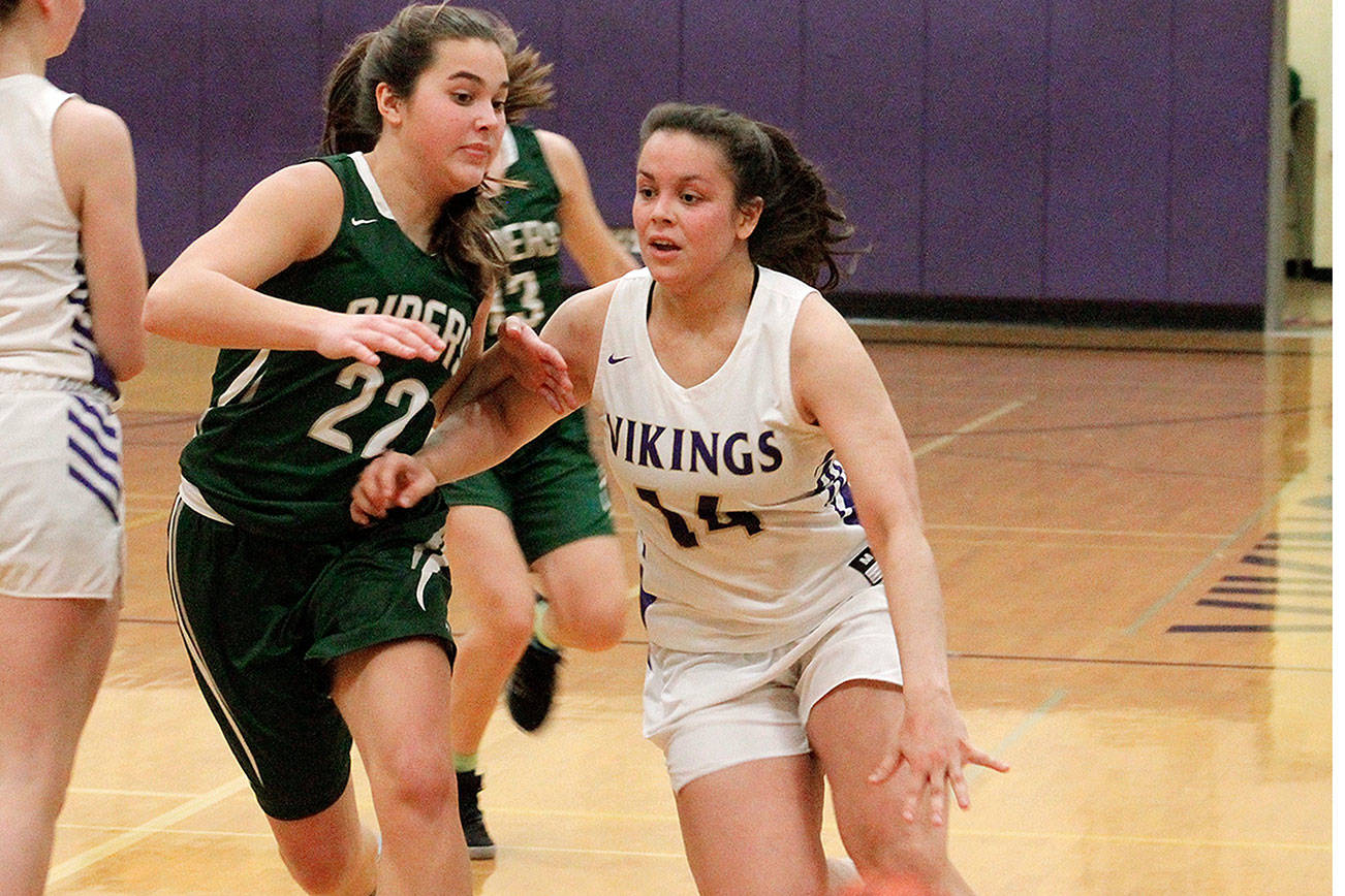 Noelani Barreith tries to get around Port Angeles’s Eve Burke (22) in the Vikings’ 67-39 loss. Barreith led the team with 12 points. (Mark Krulish/Kitsap News Group)