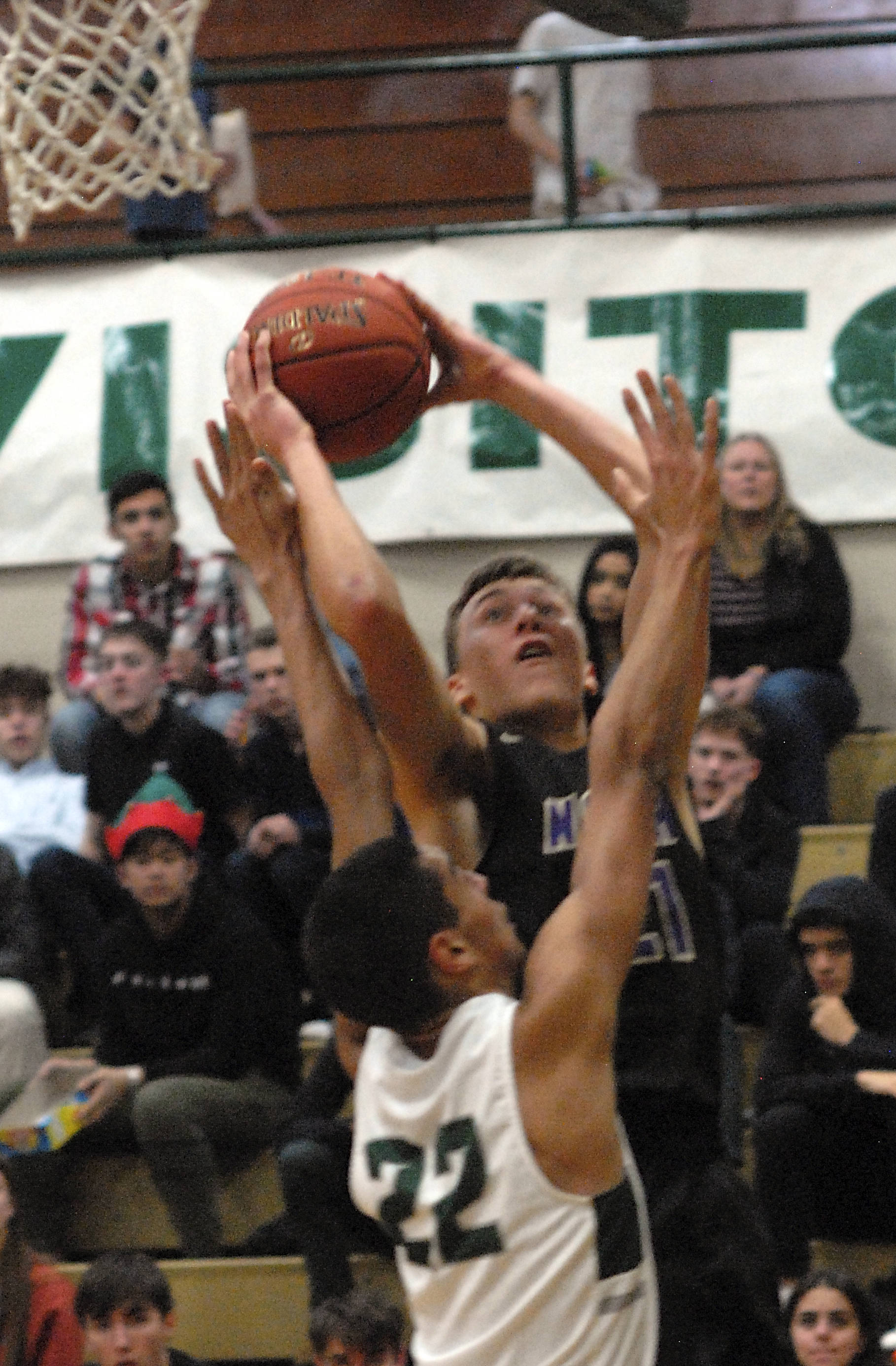 North Kitsap’s Logan Chmielewski aims for the hop over the defense of Port Angeles Damen Ringgold on Wednesday at Port Angeles High School. (Keith Thorpe/Peninsula Daily News)