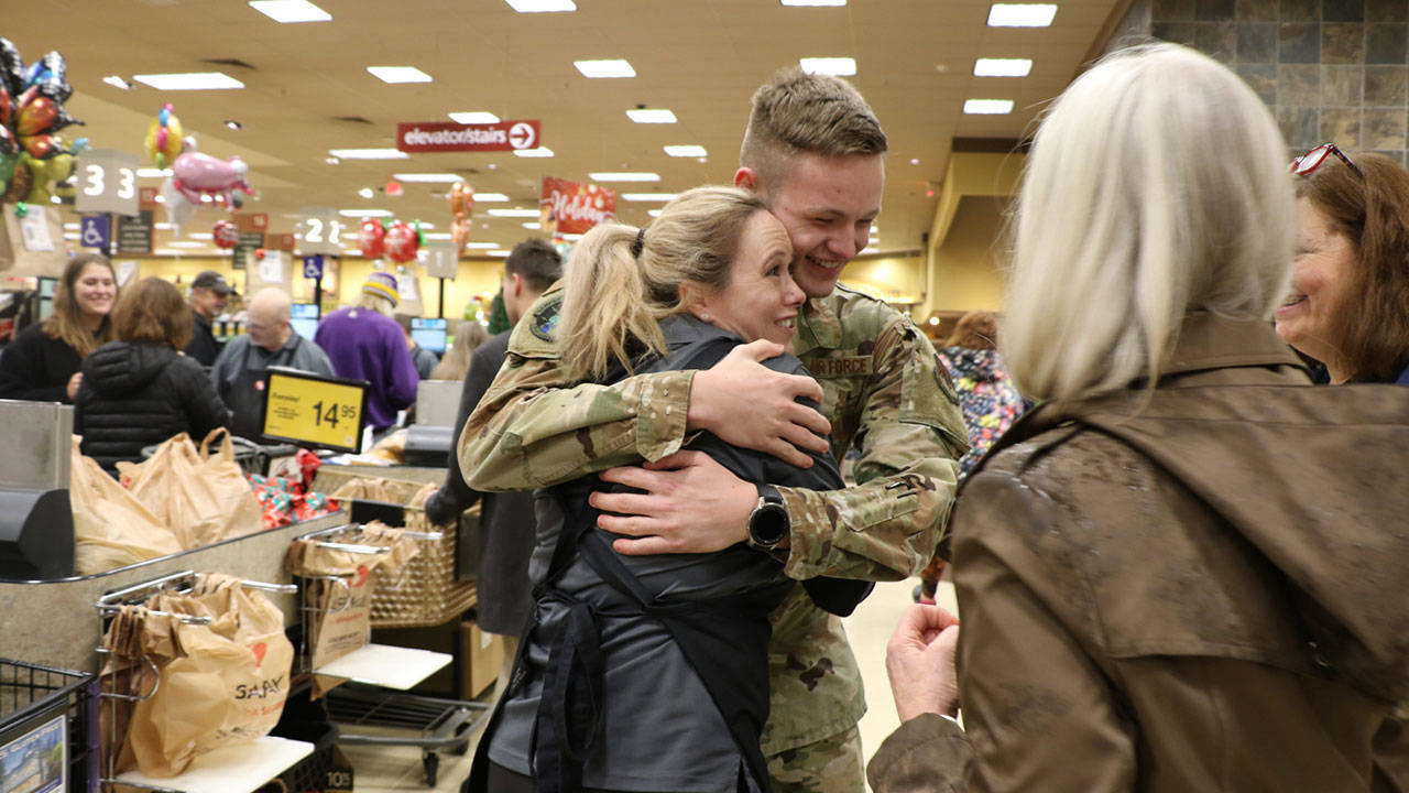 Annie Erker goes in for a second hug after her son Jaysen Keilbart surprises her at work.