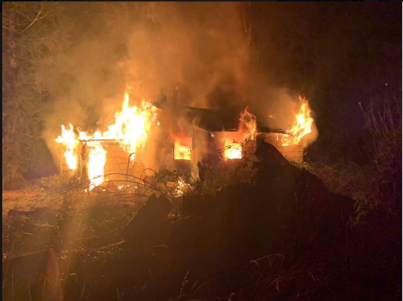 An abandoned home along Viking Way was fully engulfed in flames on Christmas Eve. (photo courtesy of Poulsbo Fire)