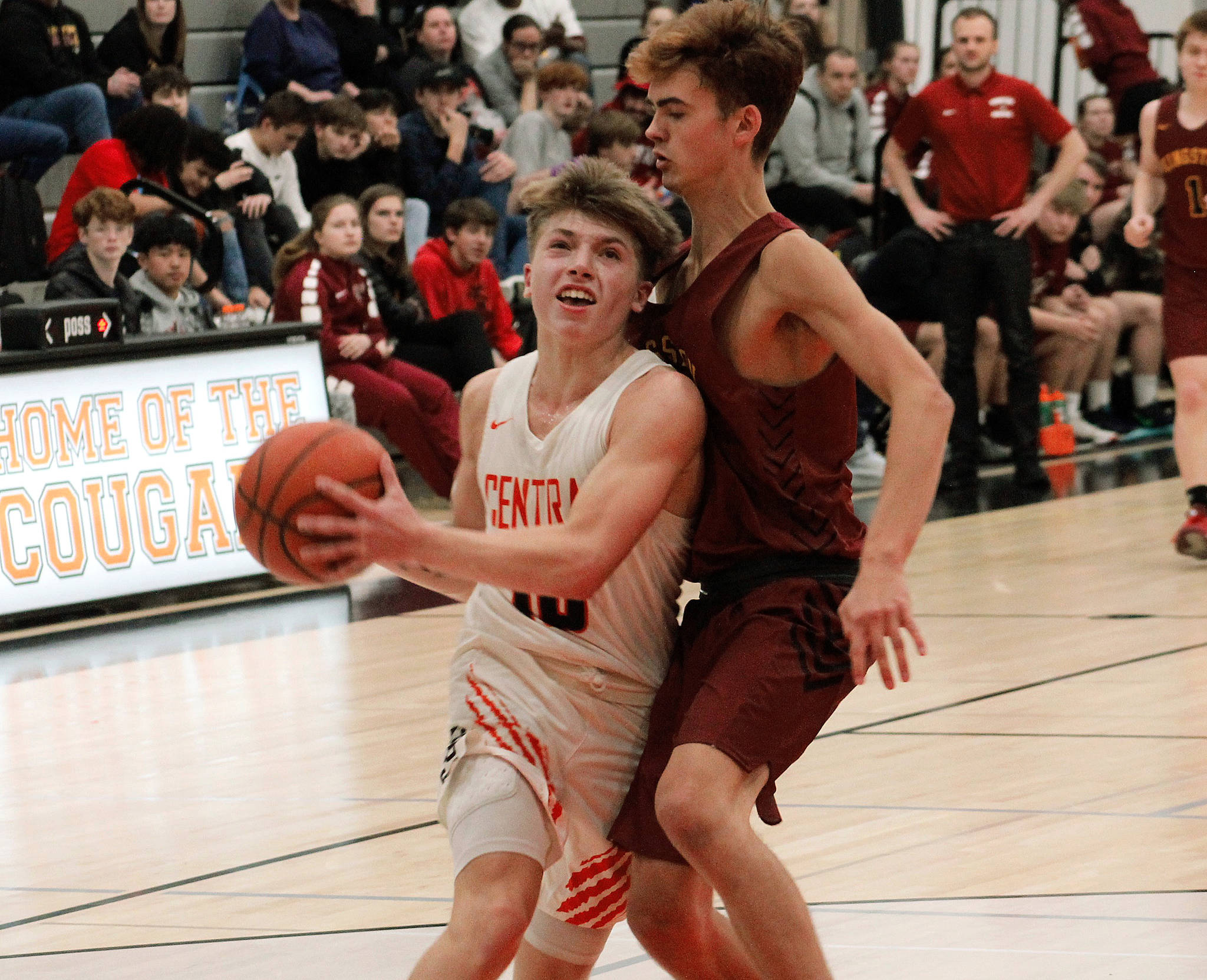 Colby White (10) tries to squeeze past Kingston Trichler in Central Kitsap’s 65-40 win over the Bucs. (Mark Krulish/Kitsap News Group)