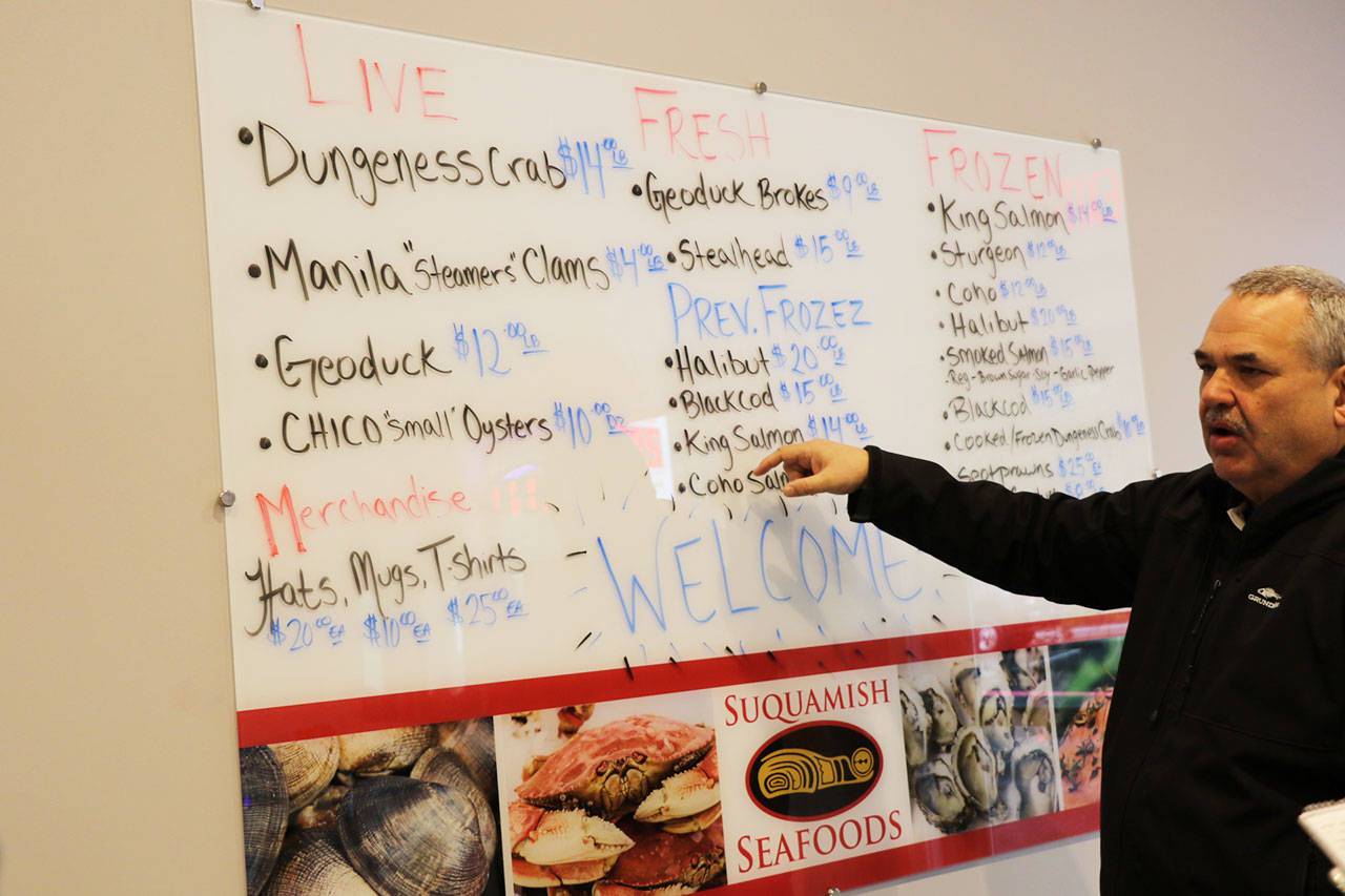 Suquamish Seafoods General Manager Tony Forsman shows off whats on the menu at the new shop.
