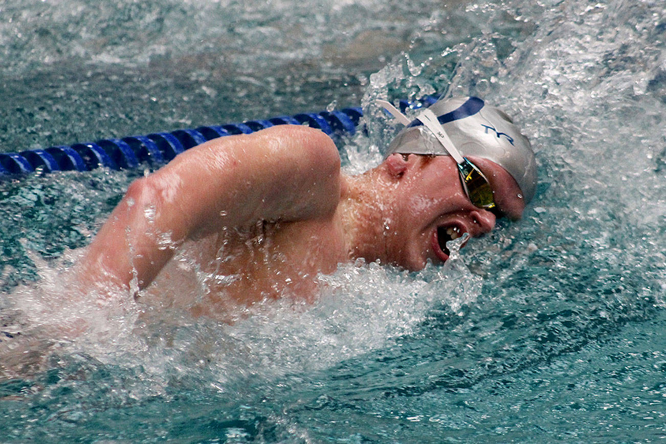 Olympic junior Ross Burchell swam state-qualifying times in the 200- and 500-yard freestyle events at Saturday’s Olympic Swimvitational. (Mark Krulish/Kitsap News Group)
