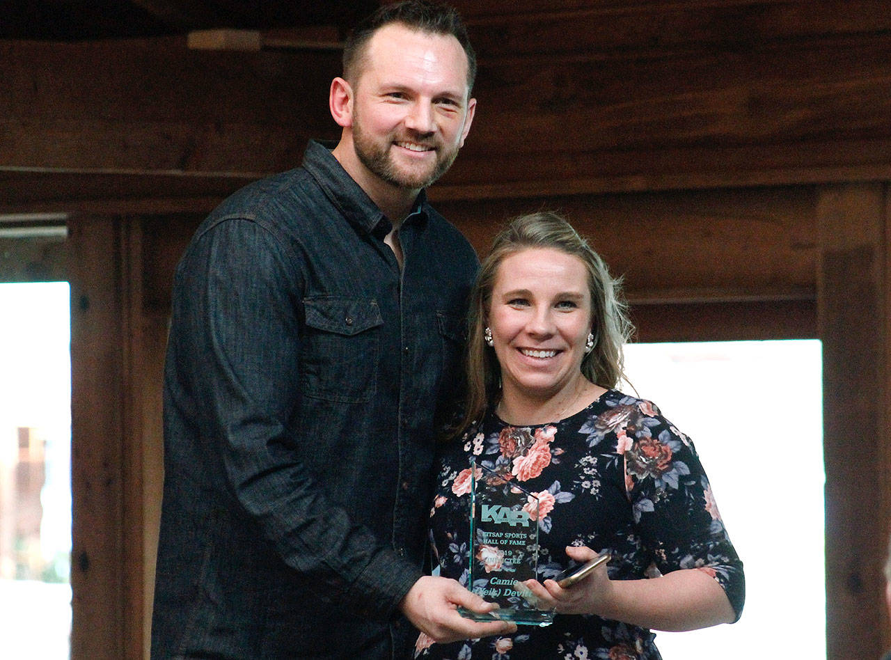 Camie Yeik Devitt receives her Hall of Fame award from Kitsap Athletic Roundtable President Noah Garguile. (Mark Krulish/Kitsap News Group)