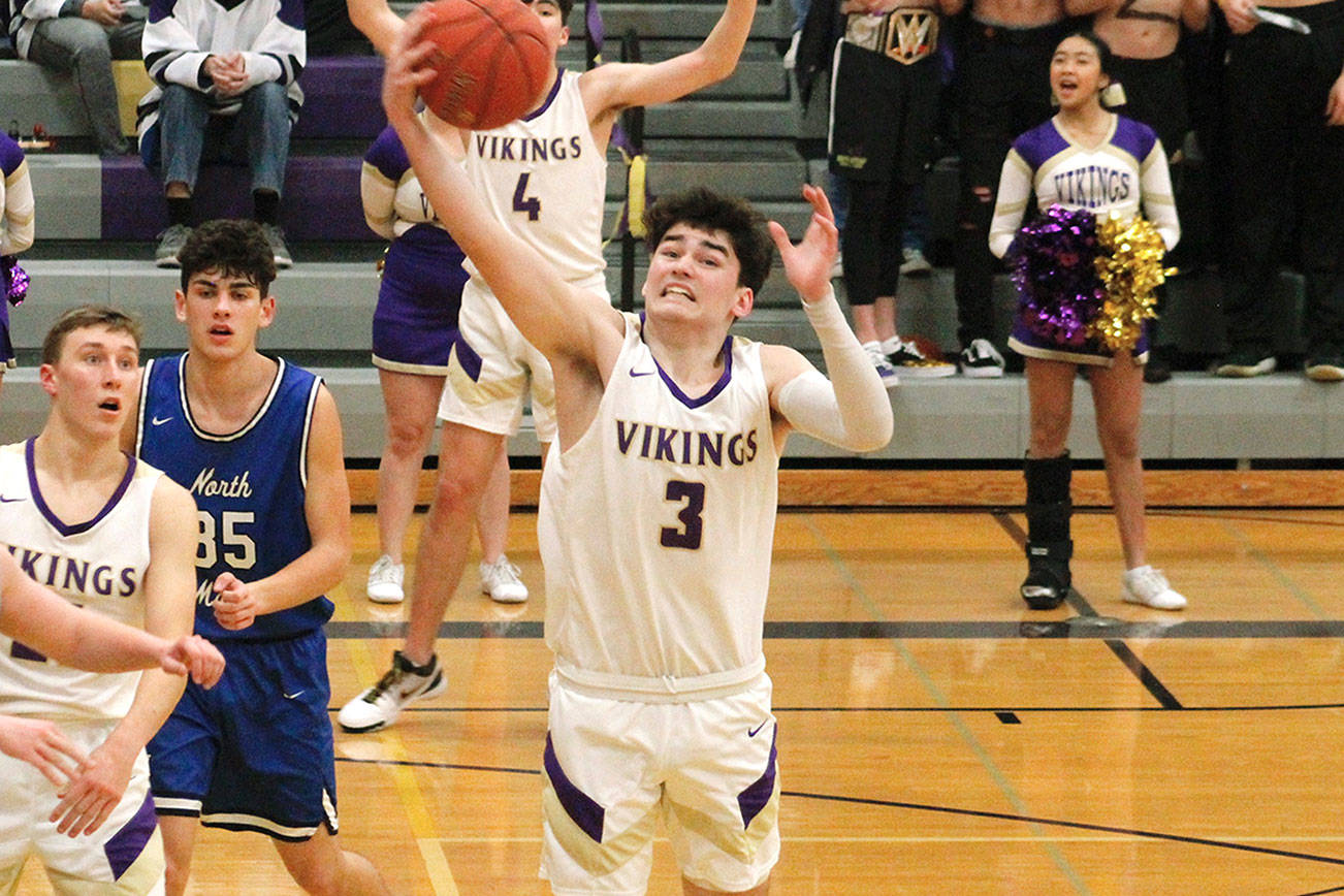 North Kitsap’s Aiden Olmstead reaches out to grab a rebound in his team’s 80-47 win over North Mason. (Mark Krulish/Kitsap News Group)