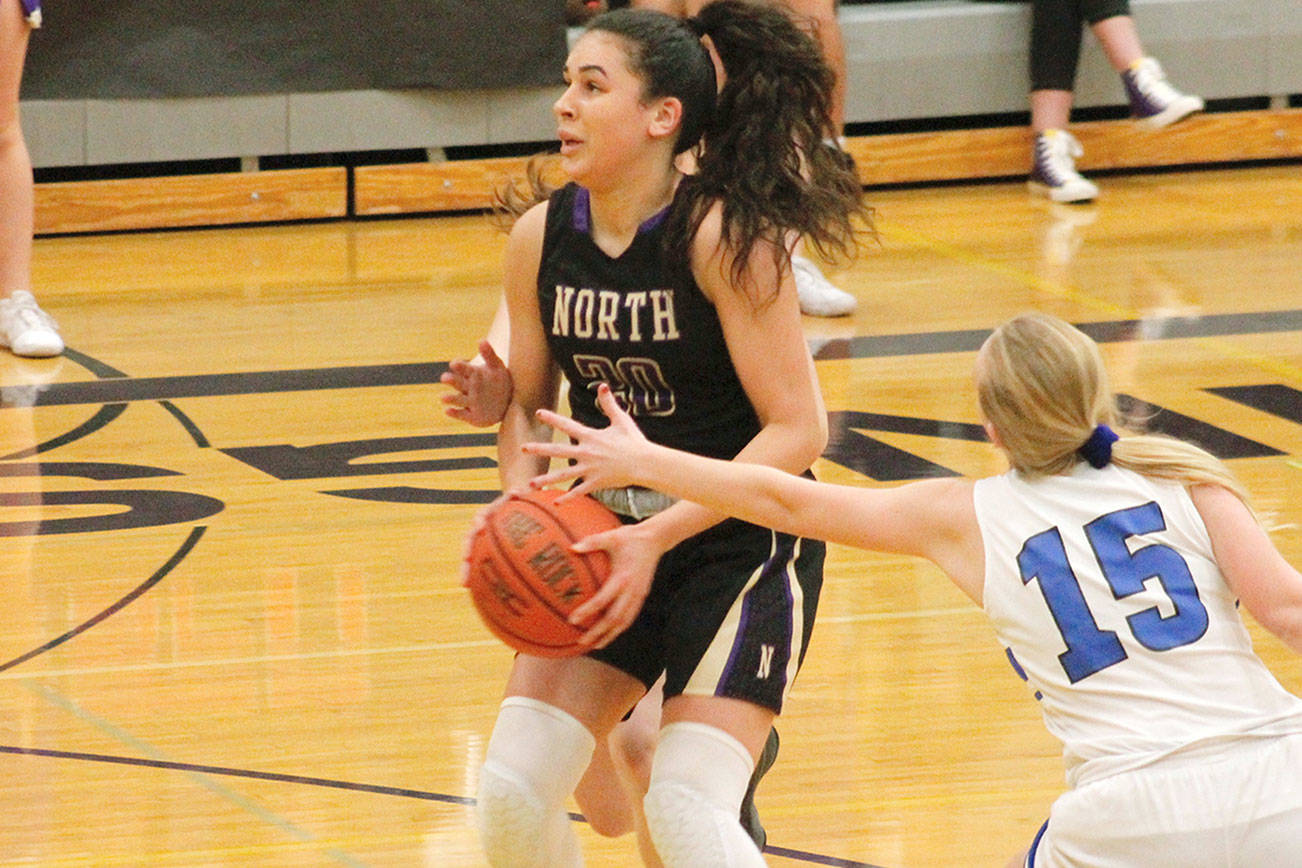 Mia McNair sidesteps the defense of North Mason’s Kirstin Griffey (15) in North Kitsap’s final regular season game against the Bulldogs. (Mark Krulish/Kitsap News Group)