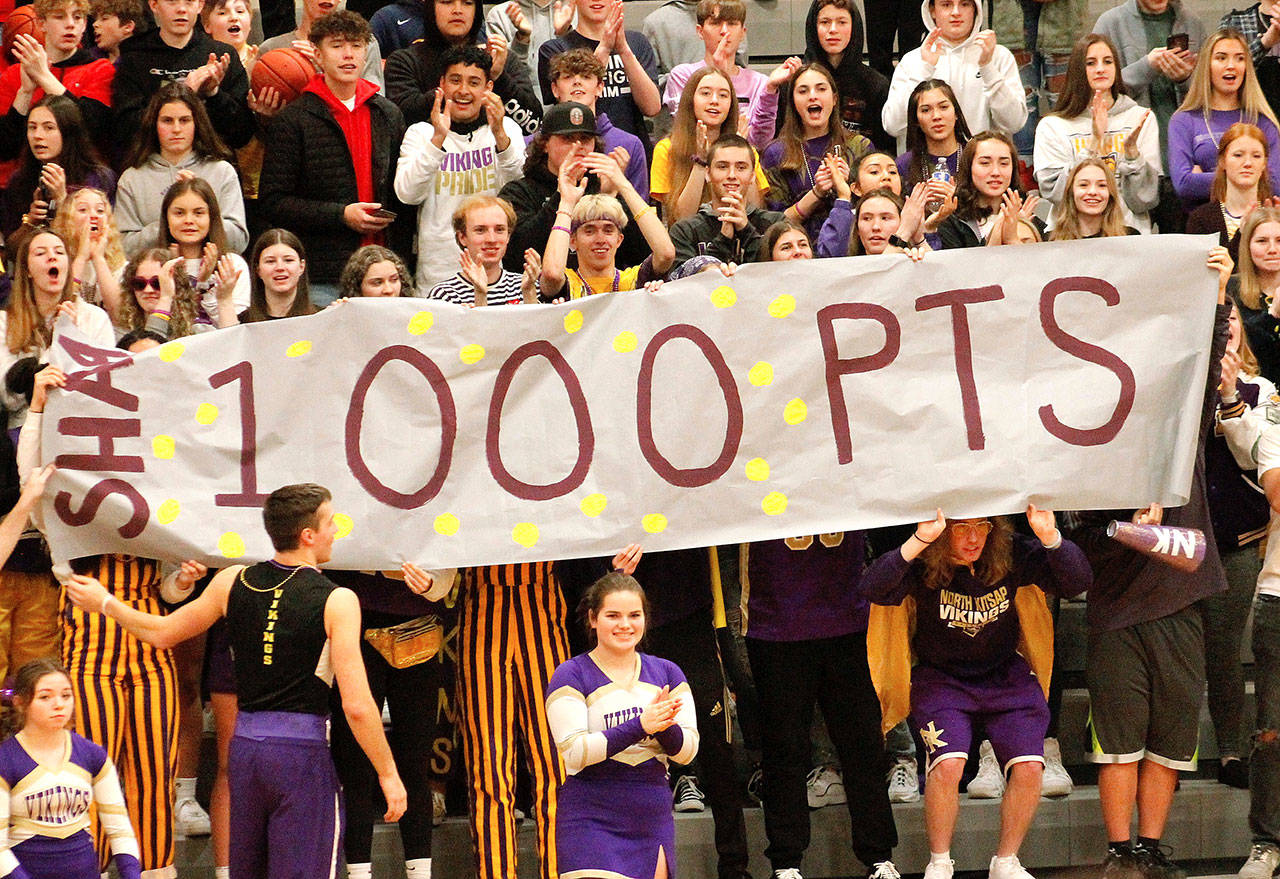 The North Kitsap student section holds up a sign for Shaa Humphrey’s 1,000th point. (Mark Krulish/Kitsap News Group)