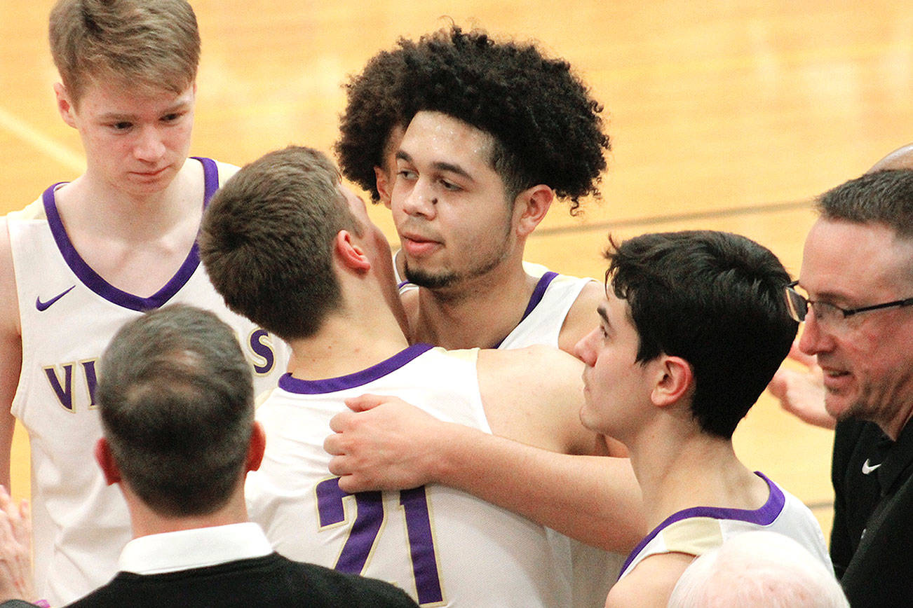 North Kitsap senior Shaa Humphrey is congratulated by his teammates after reaching the 1,000-point milestone in his team’s district win over Steilacoom. (Mark Krulish/Kitsap News Group)