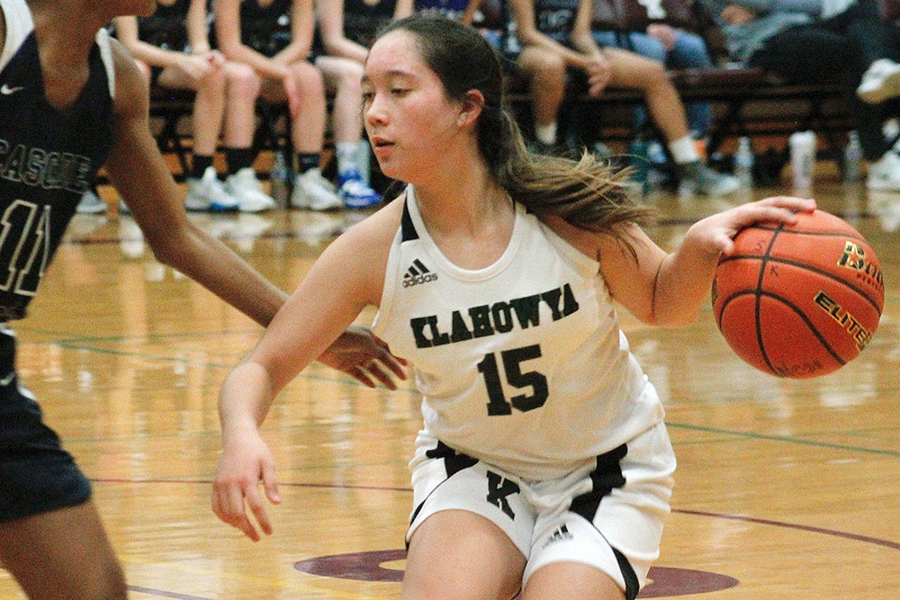 Klahowya’s Ella Koebelin tries to dodge a Cascade Christian defender in her team’s first round district game. (Mark Krulish/Kitsap News Group)