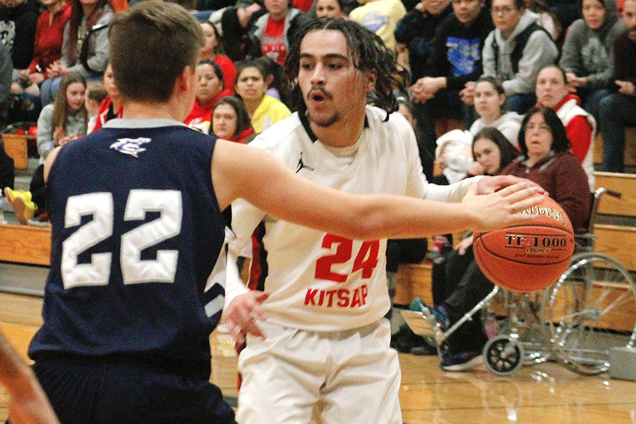 Mateo Sipai of Chief Kitsap Academy looks to get past a Puget Sound Adventist defender in the Bears’ 53-50 win in the 1B tri-district tournament. (Mark Krulish/Kitsap News Group)