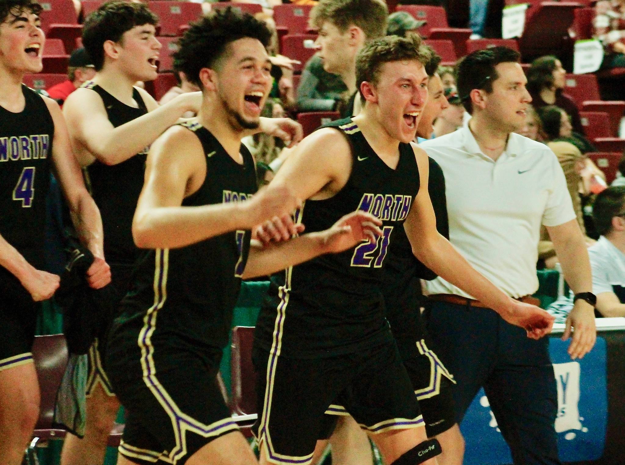 North Kitsap’s Shaa Humphrey and Logan Chmielewski, with Jonas La Tour and Aiden Olmstead in the background, run onto the court to celebrate their comeback victory in the 2A state quarterfinals over White River. (Mark Krulish/Kitsap News Group)