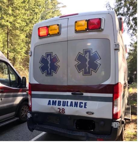 Woman strikes ambulance after following too closely near Totten Road