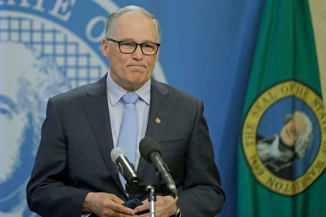 Washington Gov. Jay Inslee pauses at the end of a news conference Monday at the Capitol in Olympia. He announced that schools will remain physically closed for the remainder of the school year due to the coronavirus outbreak, and that public and private school students will continue distance learning through June. (AP Photo/Ted S. Warren)