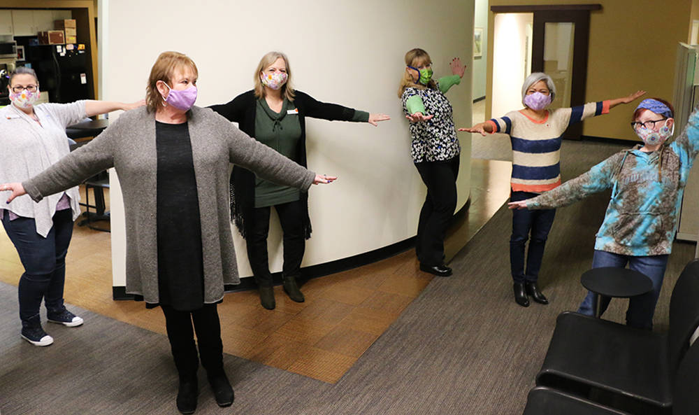 Annette Knight and her co-workers at The Doctors Clinic in Silverdale practice their social distancing with masks Knight and her friends at the Kitsap Quilters Guild made for the office. (Photo courtesy The Doctor’s Clinic)