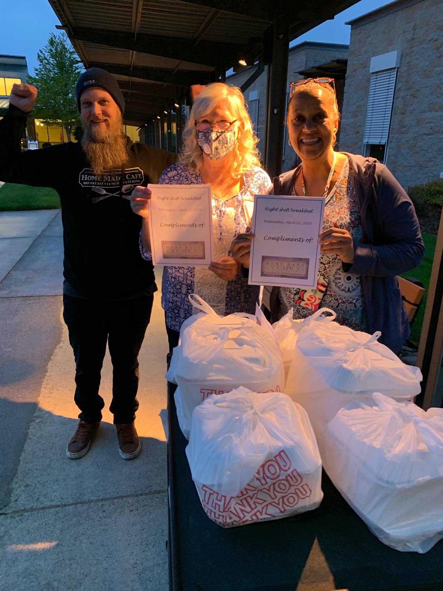 Paul Robinson from the Home Made Cafe delivers meals to the Retsil Veterans Home, received by staff members Debbie Narducci (center) and Kelly Vickers (right). (Photo courtesy of Steve Sego)