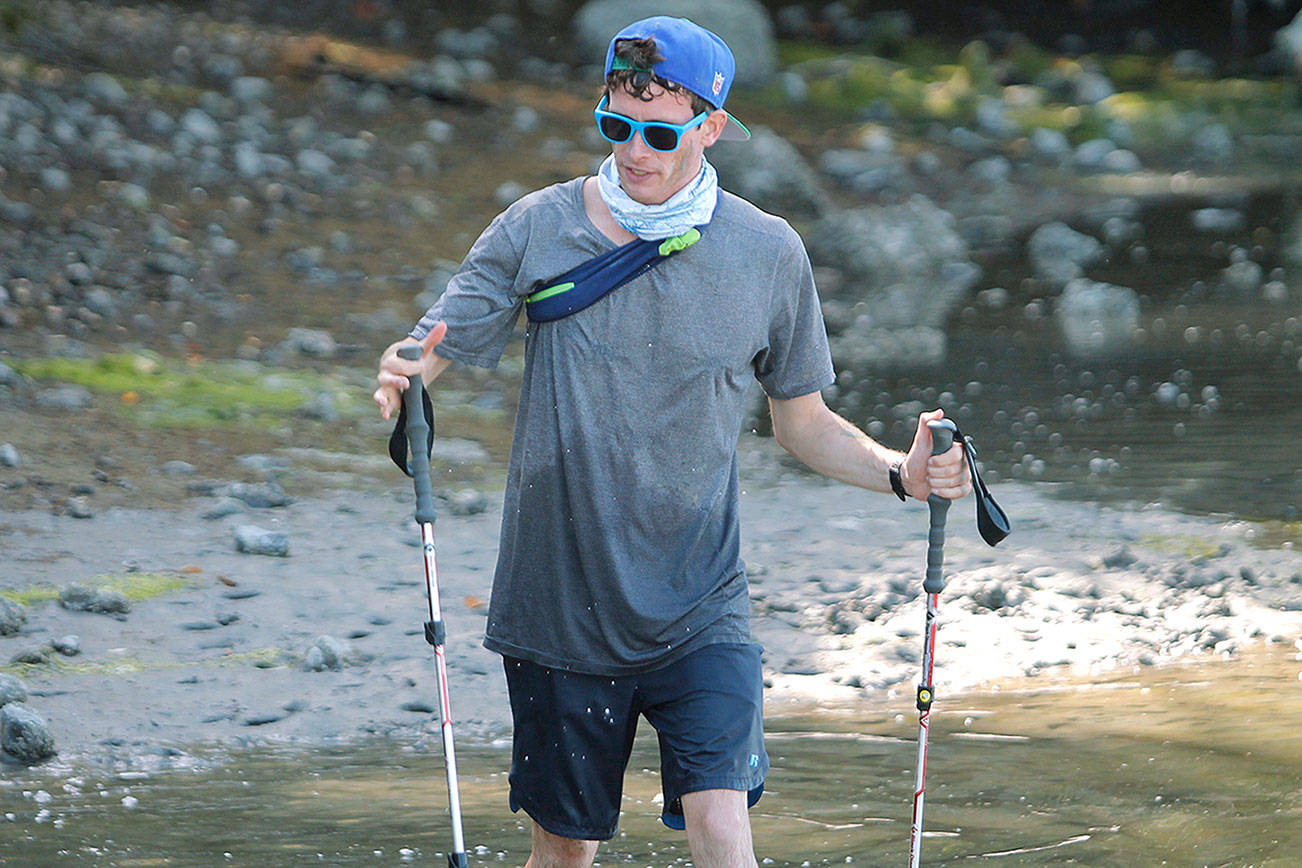 Island resident Greg Nance pulls up to the end of Point Monroe Drive near Fay Bainbridge Park during his endurance run around Bainbridge. (Mark Krulish/Kitsap News Group)