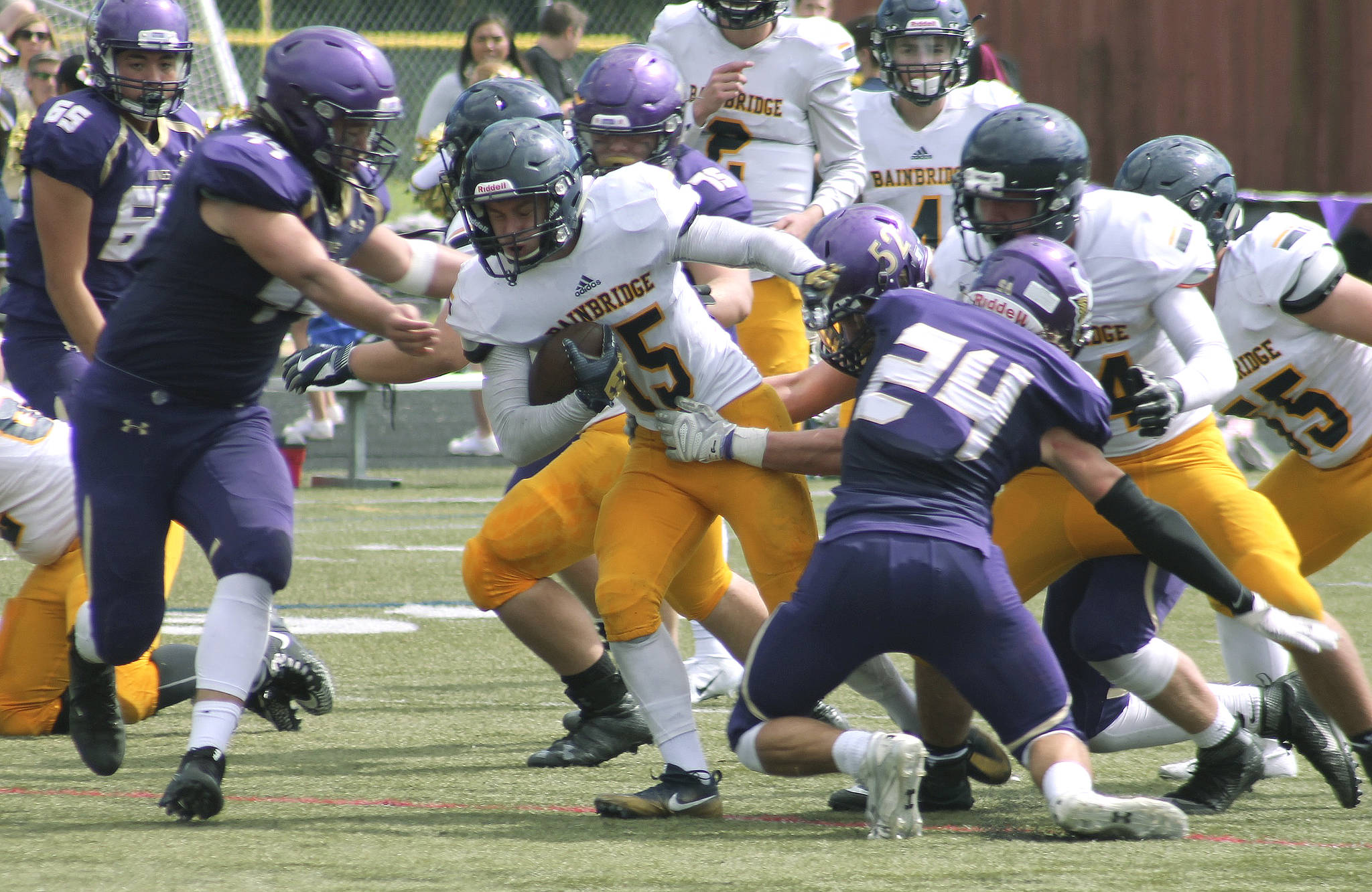 Bainbridge running back Alex Ledbetter tries to break away from the pile during the Spartans’ 2018 opener against North Kitsap. (File photo)
