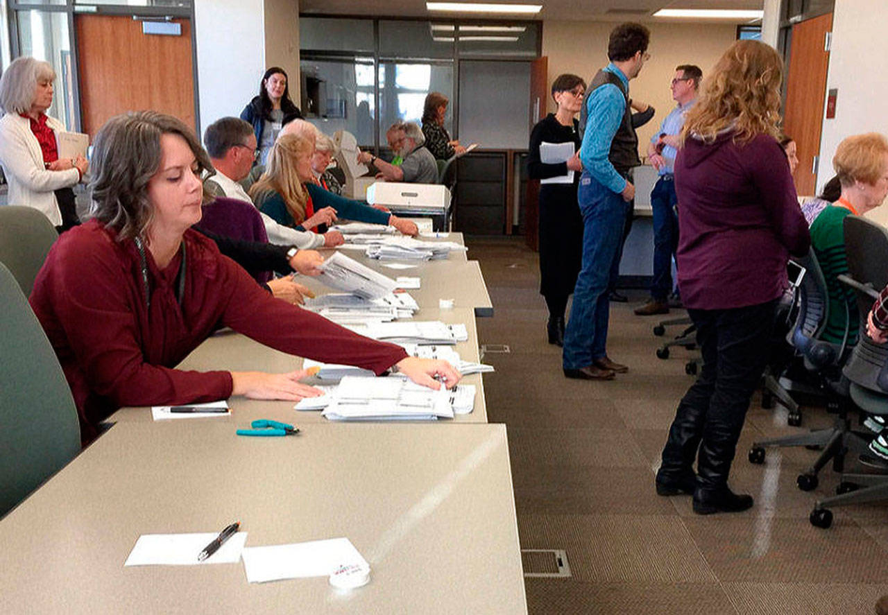 Kitsap County Elections workers manually recount ballots from the hotly contested state Senate race in the 26th Legislative District in 2018. (Bob Smith | Kitsap Daily News 2018)