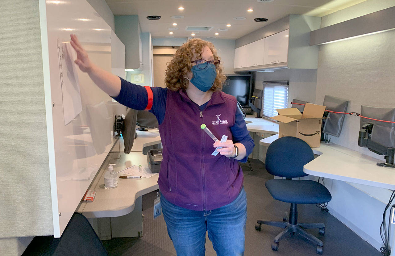 Amy Anderson with Kitsap Public Health District shows a saliva collection tube that volunteers collect at the mobile COVID-19 drive-through testing unit. (Bob Smith | Kitsap Daily News)