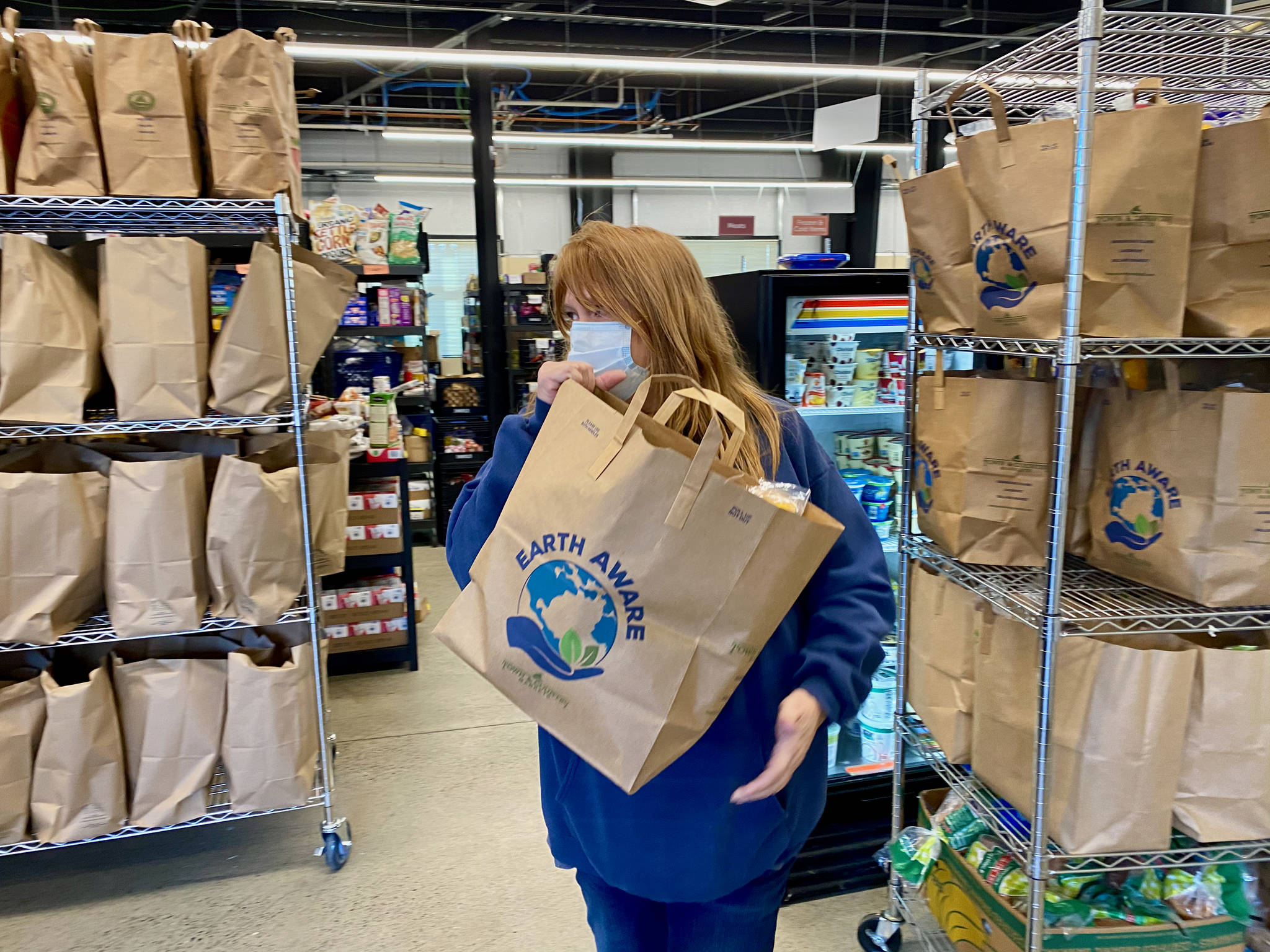 Fishline had over 400 volunteers before the first COVID shutdown. Now they have 130 volunteers packaging and delivering food to those in need. Ken Park/North Kitsap Herald photos