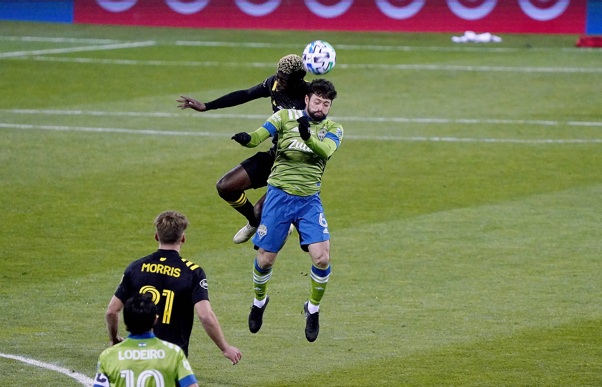 Sounders midfielder João Paulo tries to out-leap a Columbus player for the ball in the MLS Cup. (Mike Fiechtner/Sounders FC Communications)
