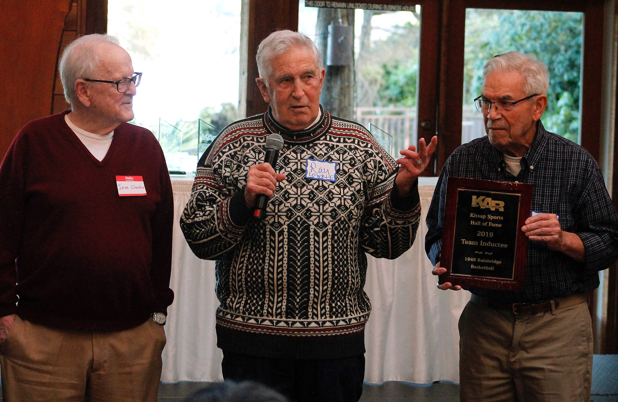 Sam Clarke, Ray Lowrie and Jim Nadeau hold up the 1948 state championship team’s commemorative plaque.