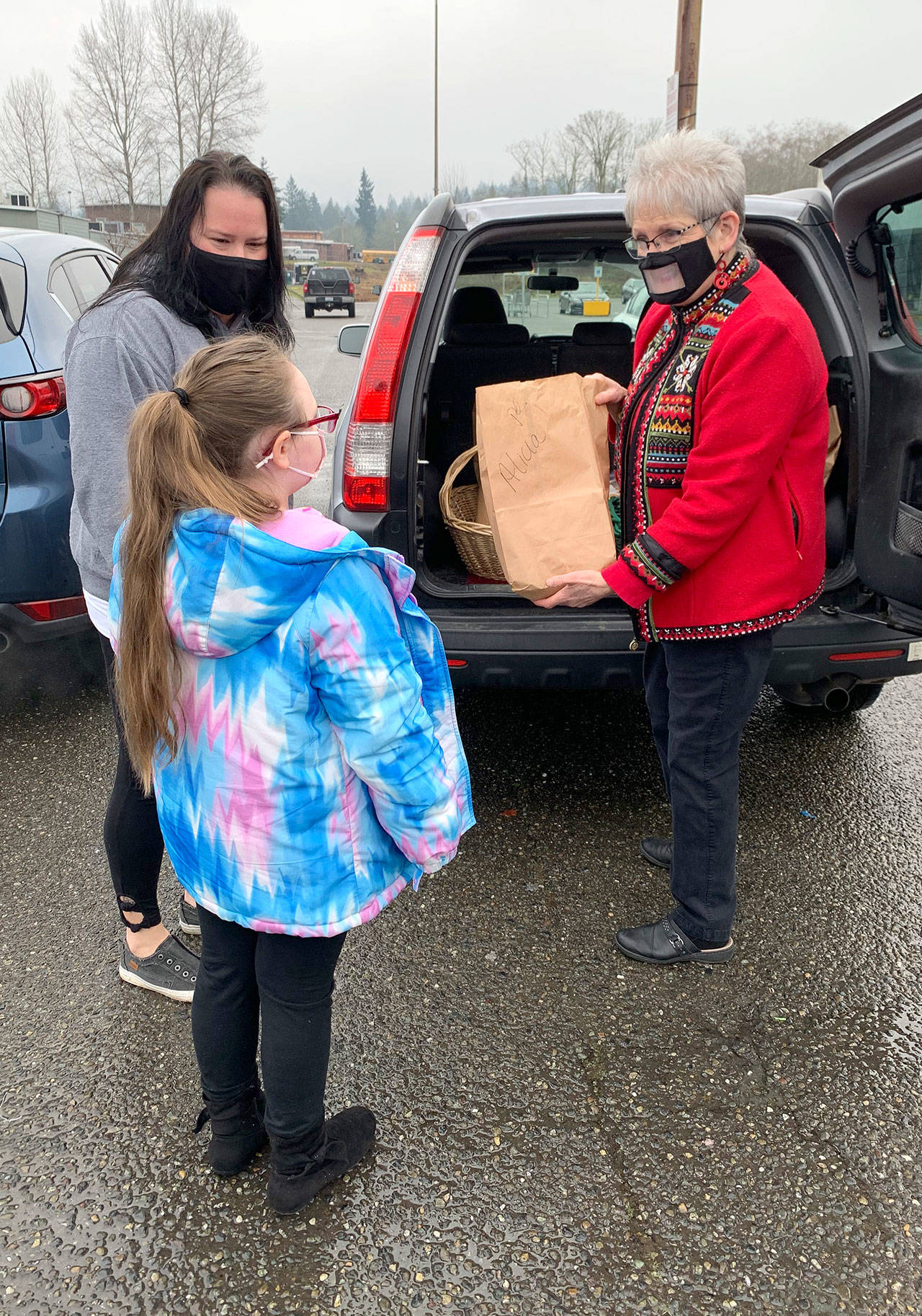 Sandi Fleury’s baking business, called “From the Garden to the Table,” started in 2018 after she decided to leave the dentistry field. Here, she delivers orders to a mom and her daughter in Port Orchard. (Bob Smith | Kitsap Daily News)