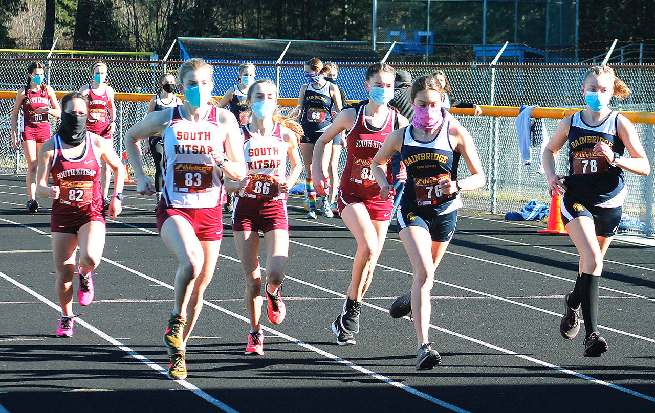 The first wave of South Kitsap and Bainbridge runners take off from the starting line. (Mark Krulish/Kitsap News Group)