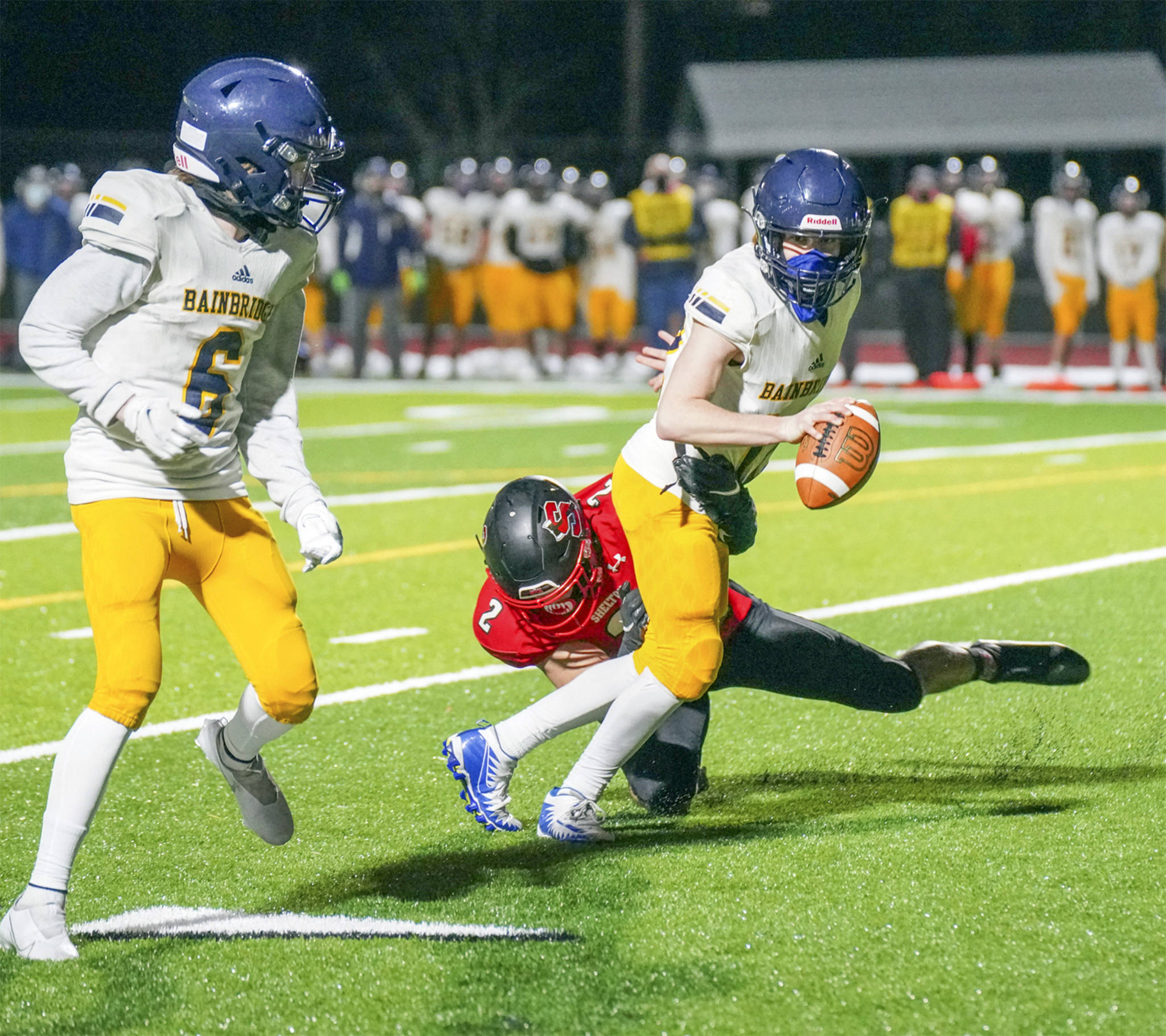 Bainbridge quarterback Gabriel Todd looks to make the pitch to running back Matt LeDorze in the season-opener against Shelton. (Photo courtesy Justin Johnson/Mason County Journal)