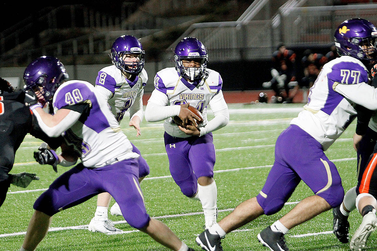 North Kitsap running back Zeke Harris leads the charge down the field in the fourth quarter. Harris scored the game-winning touchdown with under two minutes left. (Mark Krulish/Kitsap News Group)