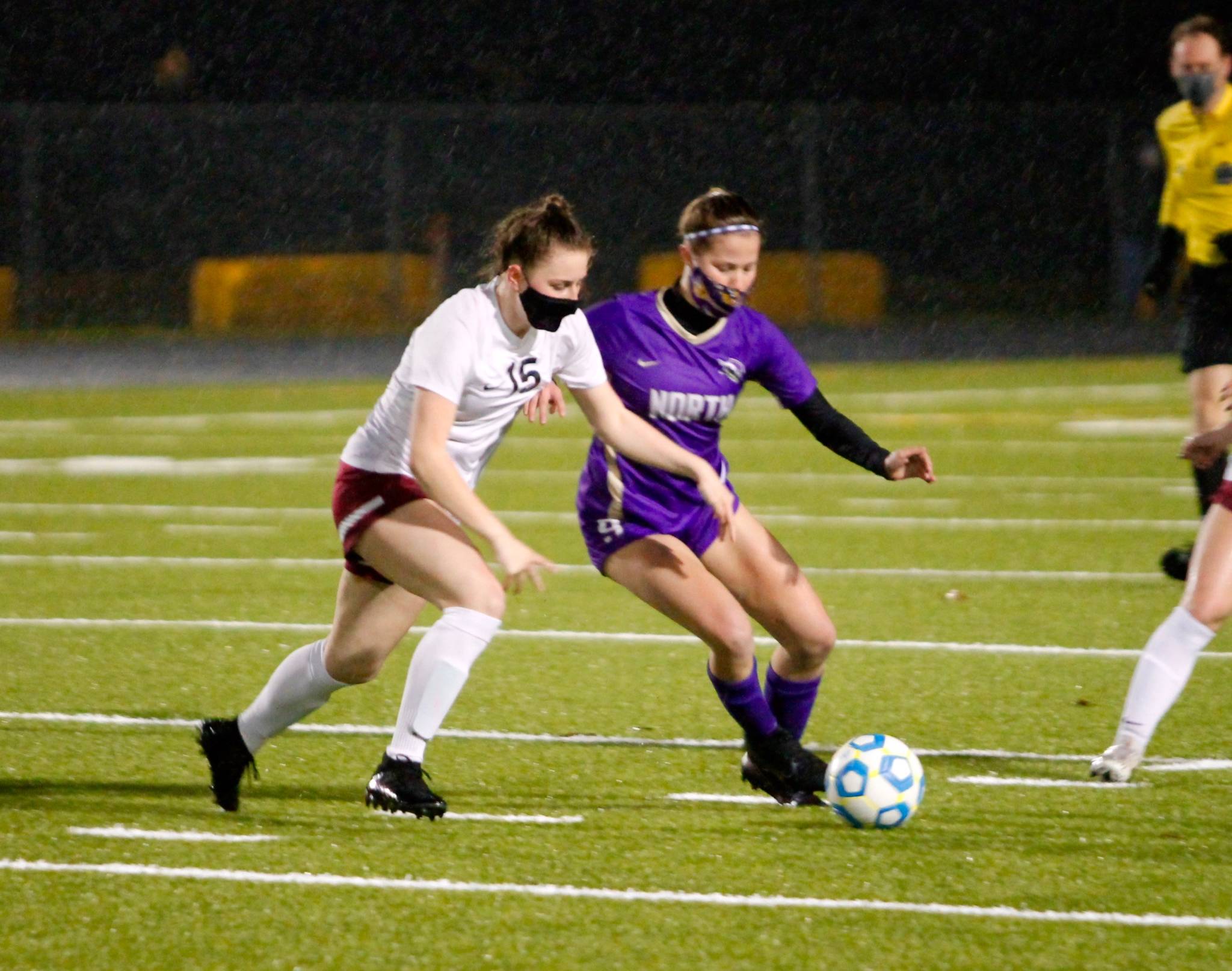 South Kitsap’s Reese Zimny (15) battles North Kitsap’s Evelyn Beers for a loose ball. (Mark Krulish/Kitsap News Group)