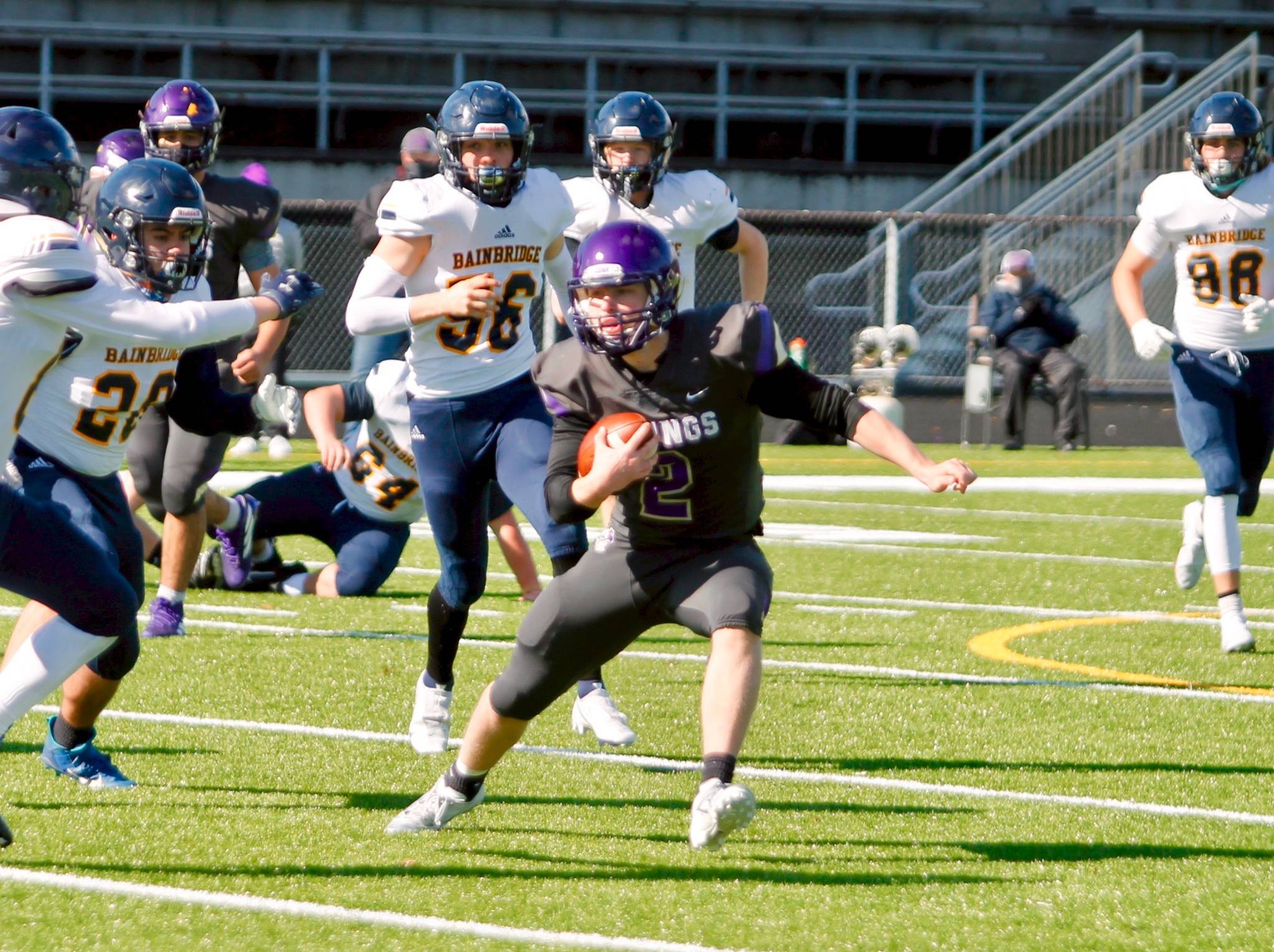 North Kitsap quarterback Colton Bower looks to get outside on a scramble against the Bainbridge defense. (Mark Krulish/Kitsap News Group)