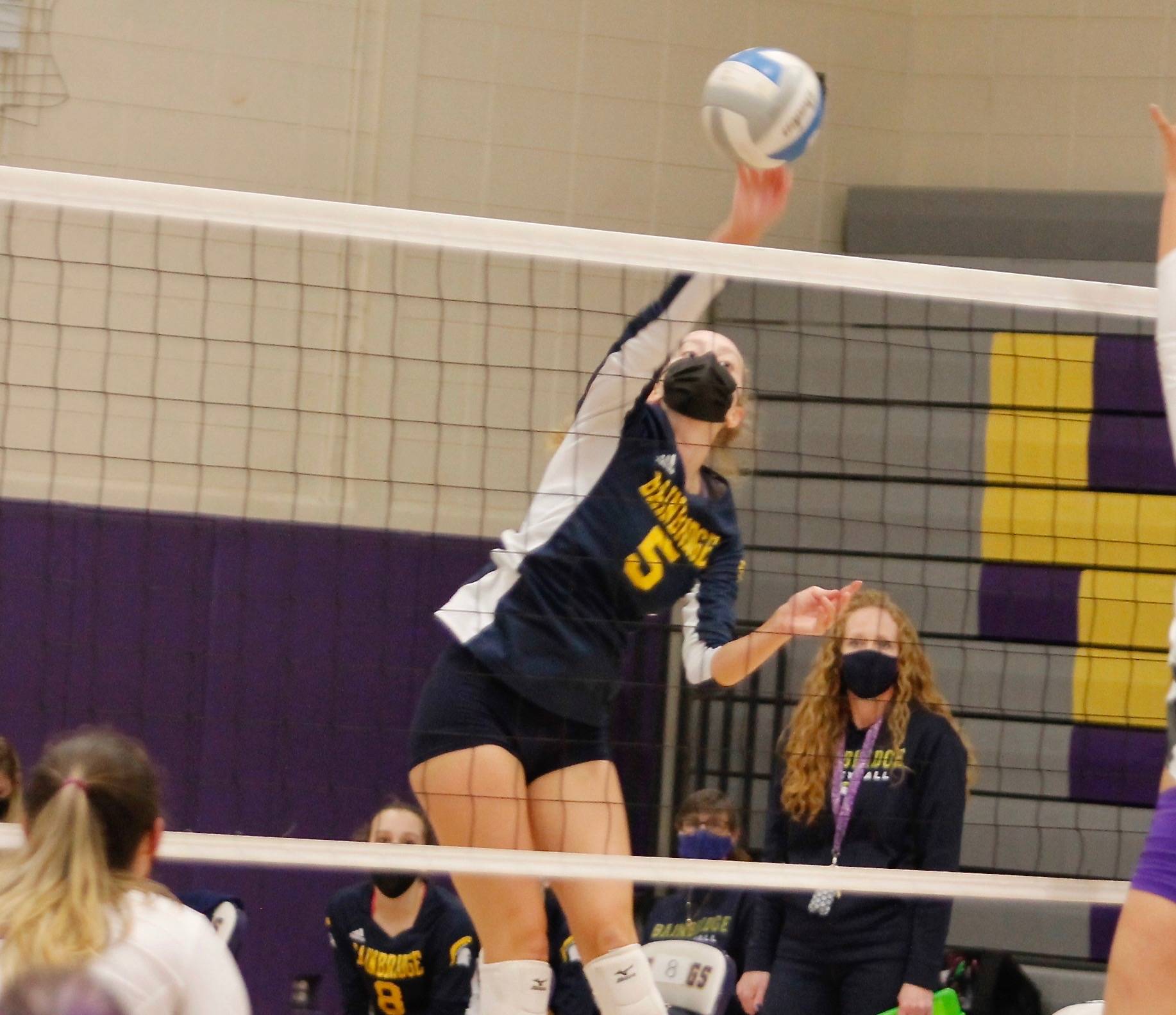 Isabelle Prentice goes up high in the air for Bainbridge to tip a ball over the net. (Mark Krulish/Kitsap News Group)