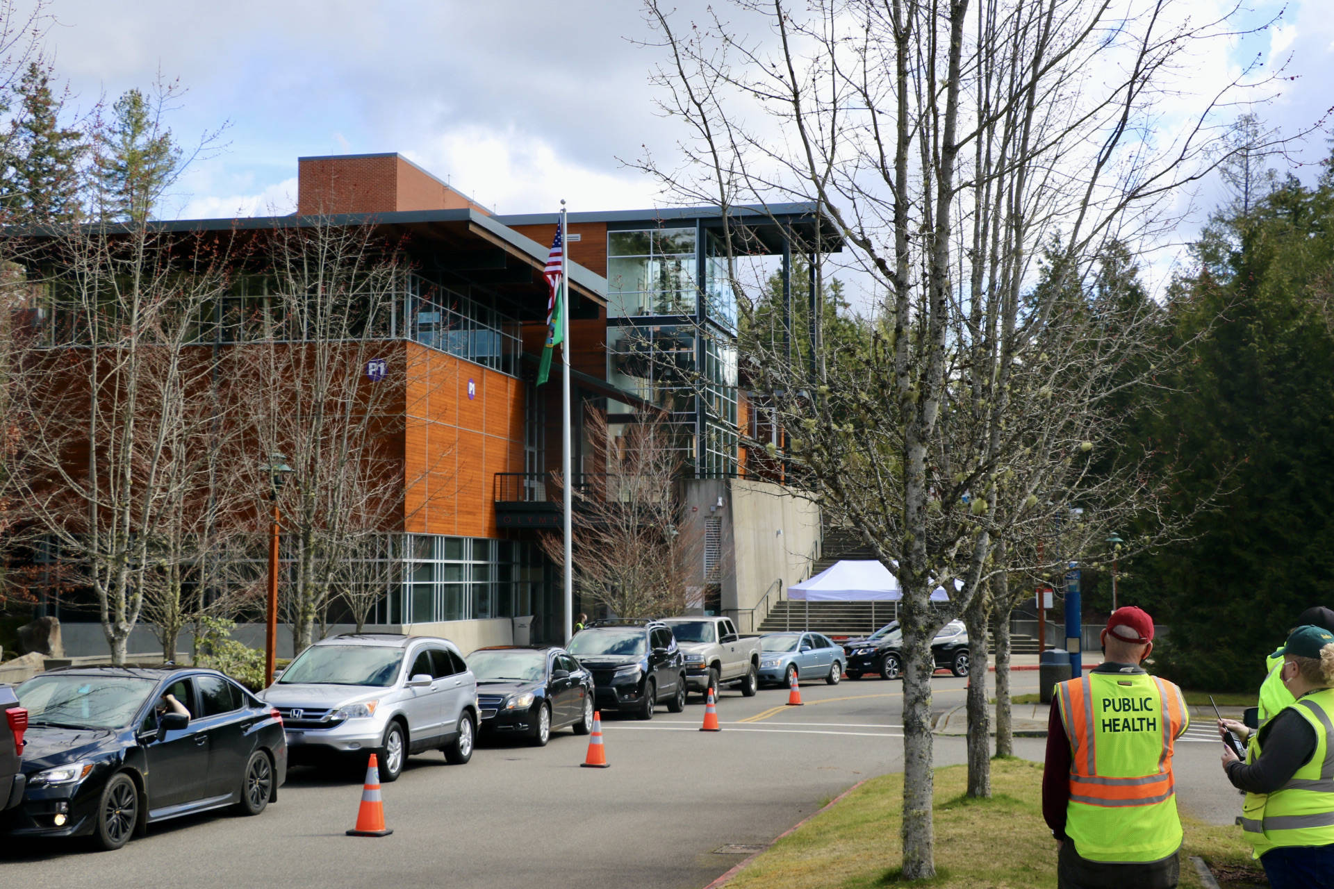 <em>Cars line the parking lot of Olympic College in Poulsbo as eligible folks wait to get their COVID-19 vaccine.</em>		 Ken Park/North Kitsap Herald
