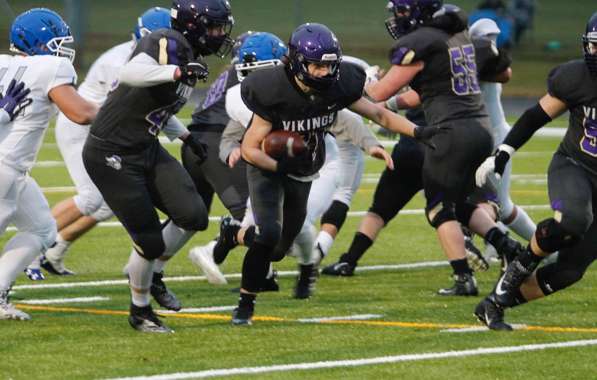 North Kitsap running back Kelly Wanzek bursts through the line during Thursday night’s win over Olympic. (Mark Krulish/Kitsap News Group)