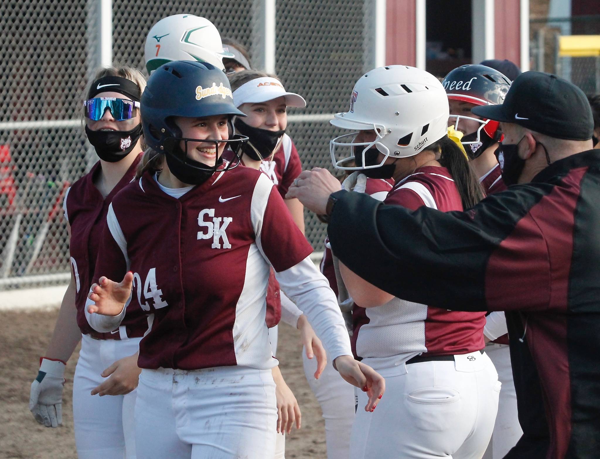 Emma Stamp is all smiles as she celebrates one of her two home runs against Curtis in South Kitsap’s first game of the season. (Mark Krulish/Kitsap News Group)