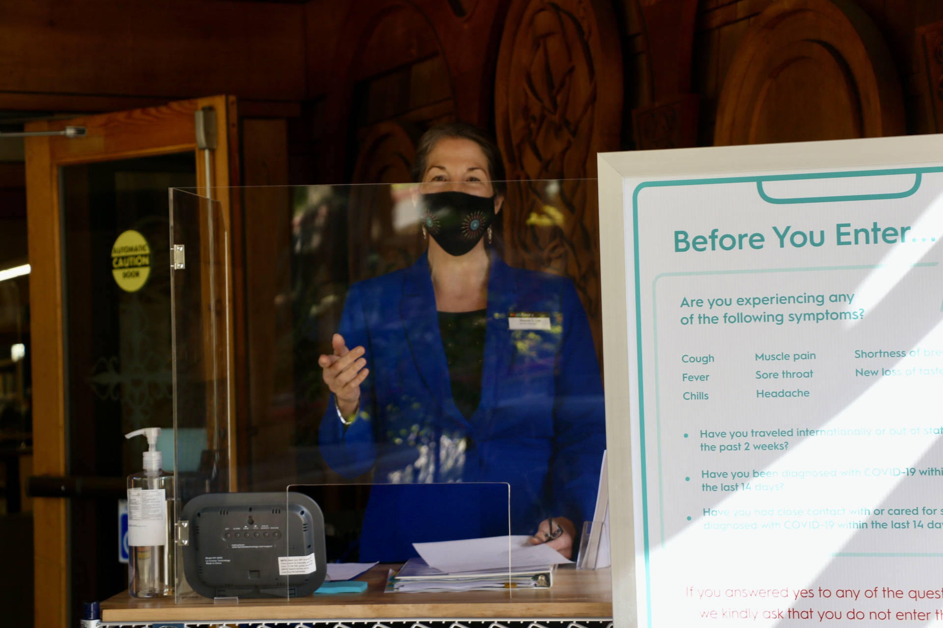 <em>Patrons to the Poulsbo Library will be greeted by folks like branch manager Sharon Lee and will be asked to sanitize their hands and go through the symptom checklist before entering the building. </em><em> </em>Ken Park/North Kitsap Herald