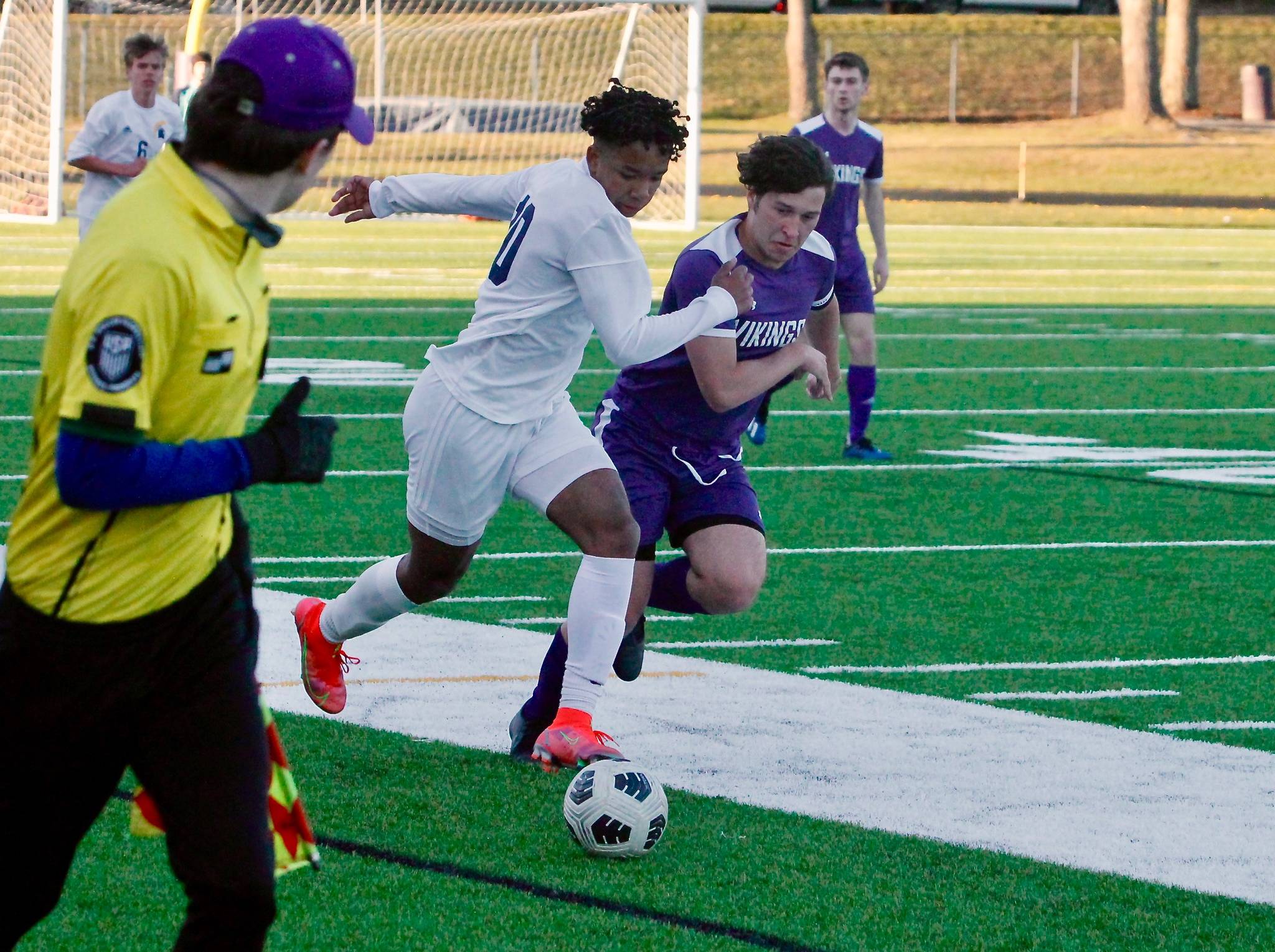 Bainbridge forward Damoni Mckenna-Greenawalt looks to break away down the sideline as North Kitsap’s Dylan Brindle gives chase. (Mark Krulish/Kitsap News Group)