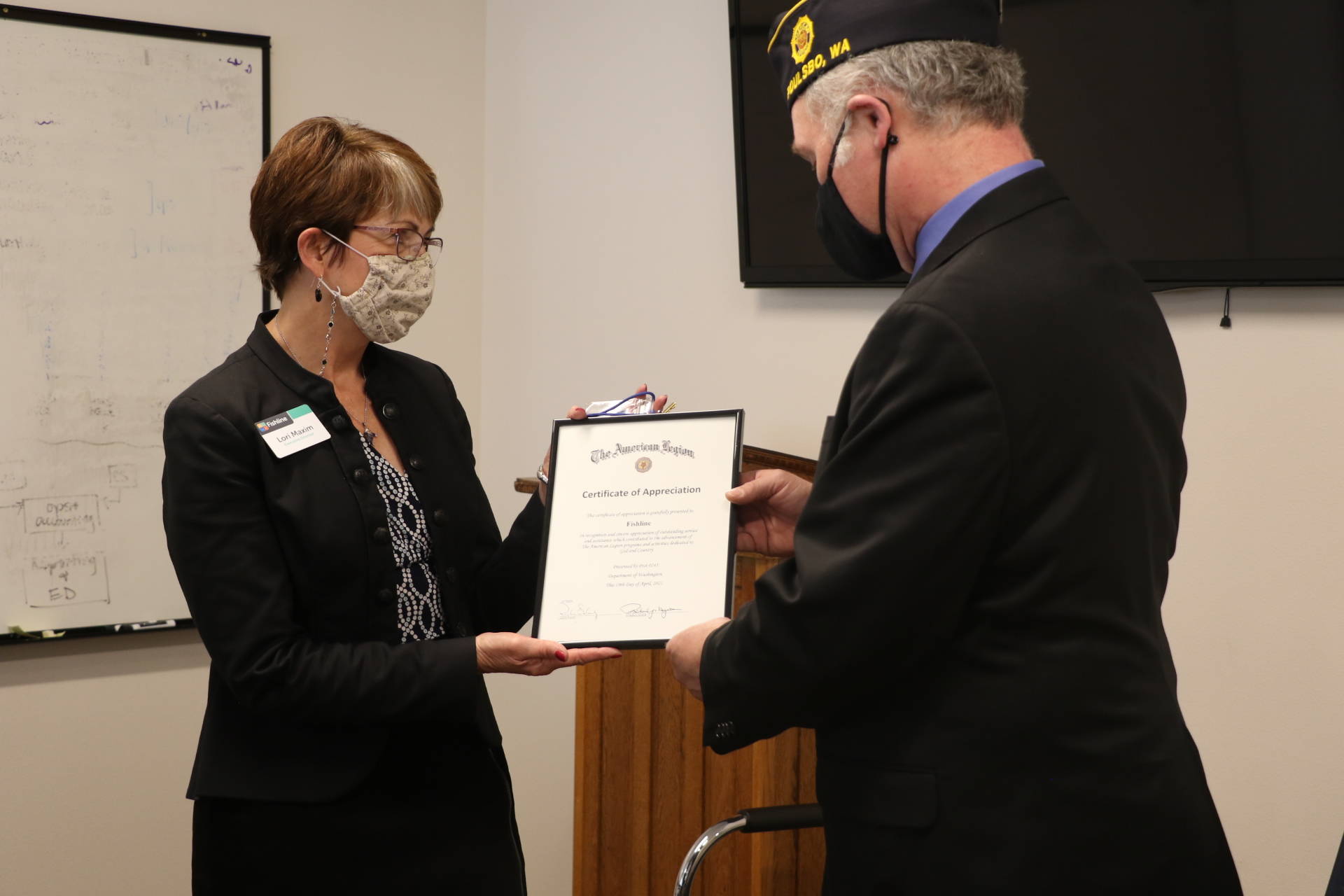 Rich Nugent, with American Legion Post #245, presented an award and check for $5,000 to Fishline executive director Lori Maxim. The American Legion is one of Fishline’s partners in caring for the most vulnerable in the community. Ken Park/North Kitsap Herald