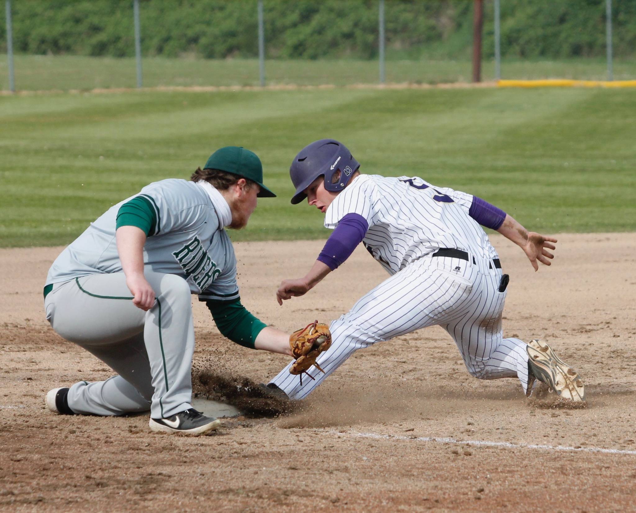 North Kitsap's Colton Bower slides in ahead of Seth Woods's tag. (Mark Krulish/Kitsap News Group)